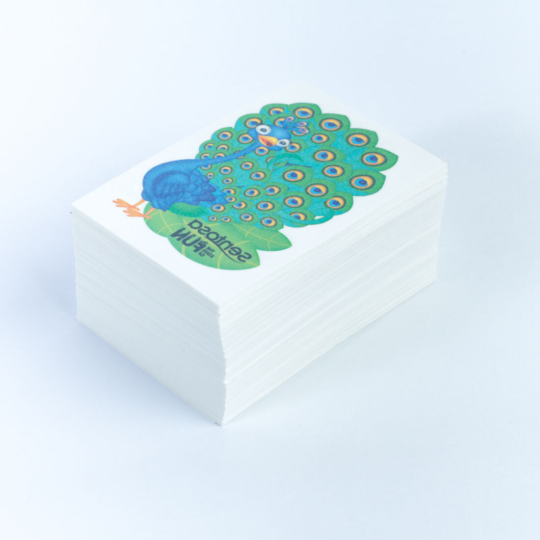 Loose custom temporary tattoos stacked and bundled for bulk packing at an event tattoo booth