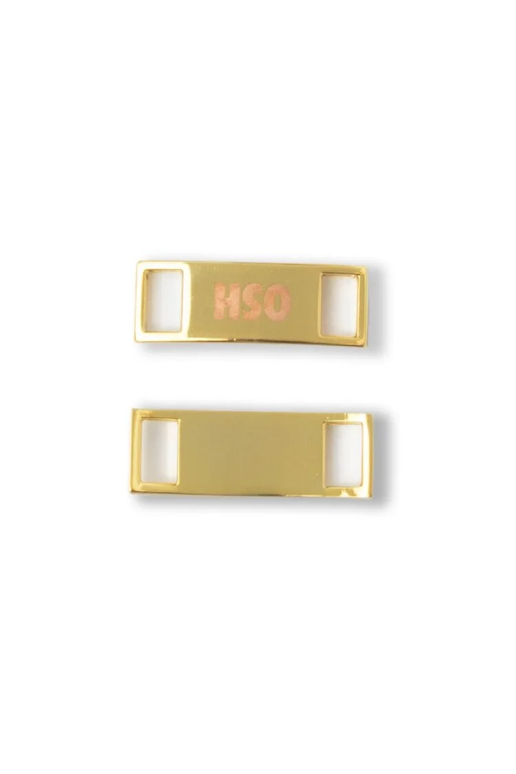 Gold shoe dubrae with a laser printed logo in pink, shown front and back