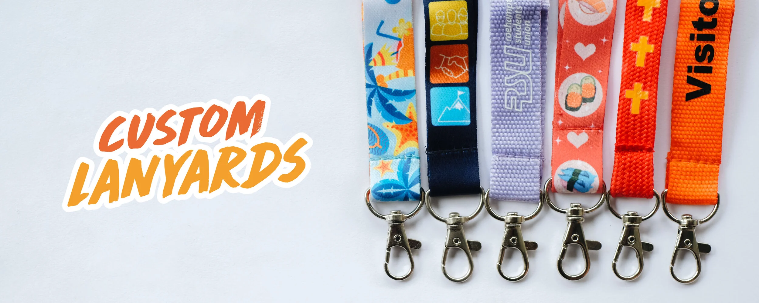 Custom Lanyards - six printed lanyards in different colours hanging in a row, including a Visitor pass