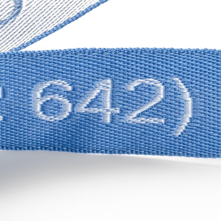 Close up of a woven jacquard lanyard with 642 raised and embroidered into the blue webbing