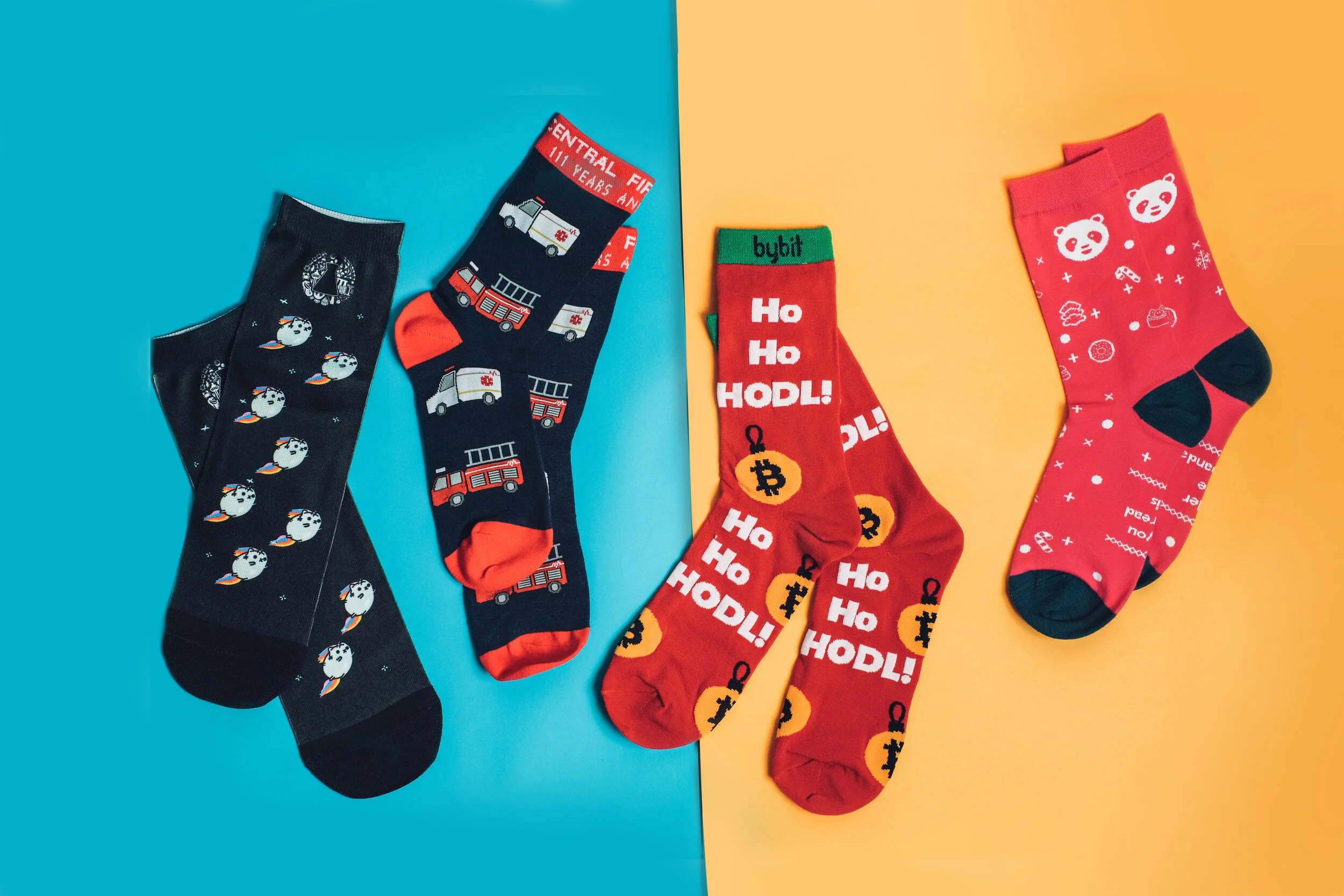 Three pairs of custom knitted socks in crypto and festive designs, including a Ho Ho HODL pair