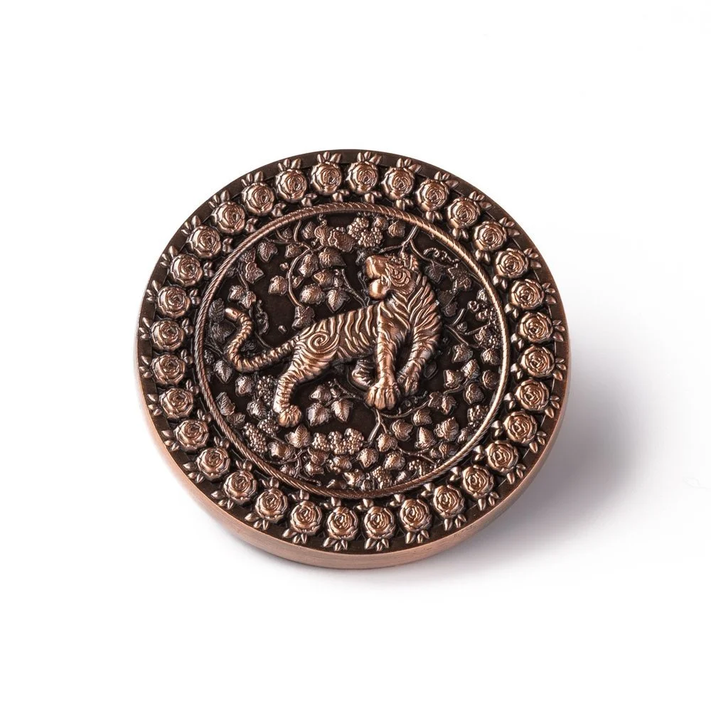 3D coin in antique copper with a tiger and floral border sculpted in raised relief