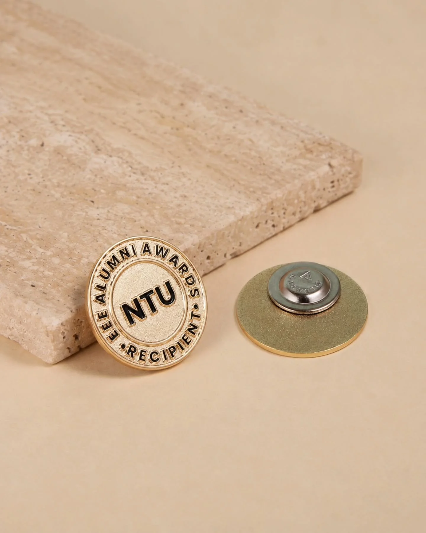 Wear your achievements with pride! 🏅✨

We crafted these elegant gold lapel pins for the NTU EEE Alumni Awards. Featuring a textured gold finish and crisp black detailing, these custom pins are the perfect way to honor distinguished recipients and fo