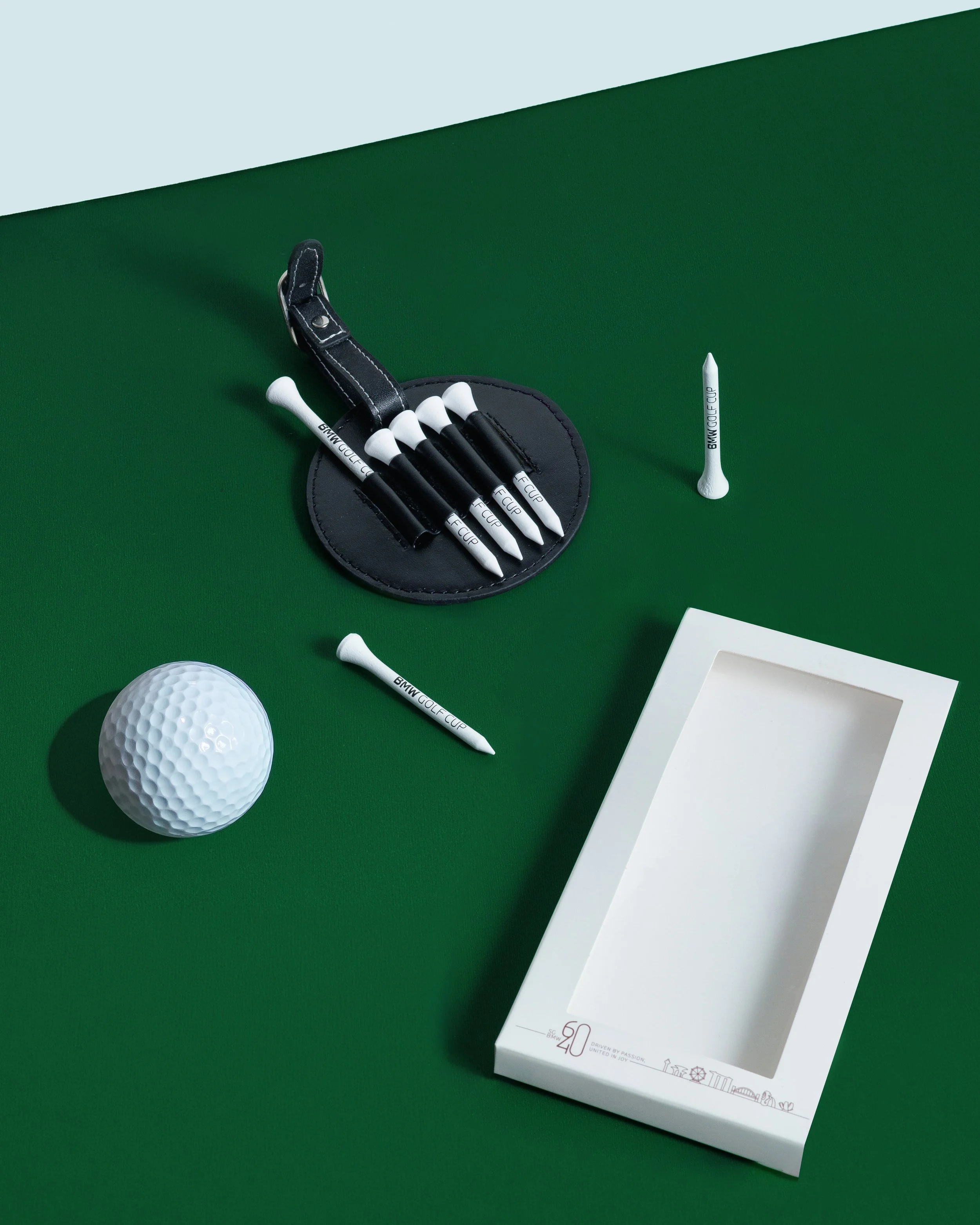 Elevate the game with merchandise that matches the prestige of the occasion. We crafted this exclusive custom golf tee set and premium leather holder for the BMW Golf Cup. High end sports merchandise like this enhances the player experience and serve