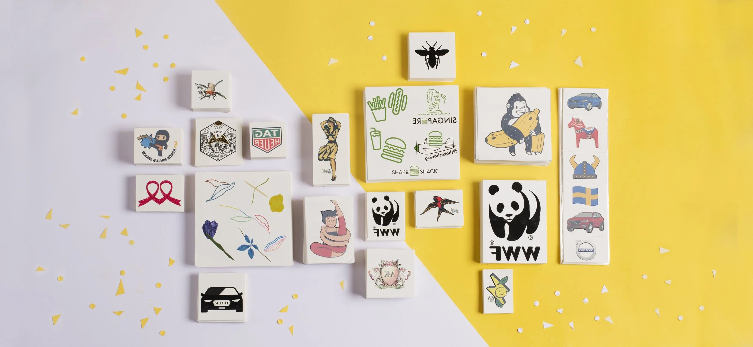 Flat lay of custom printed temporary tattoo sheets produced for corporate, charity and event campaigns