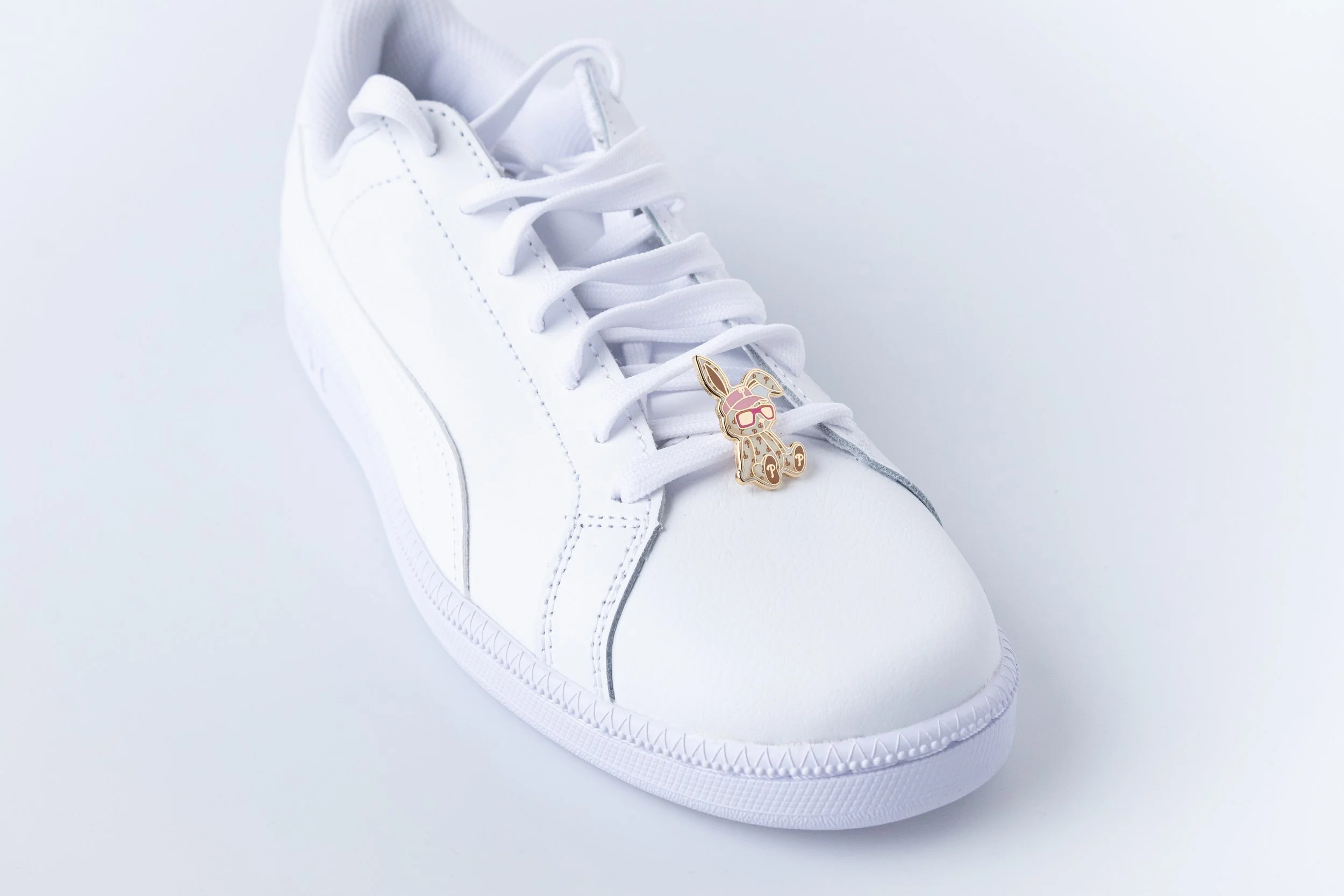 MLB CNY Year of Rabbit charm in cap and sunglasses clipped to the laces of a white sneaker