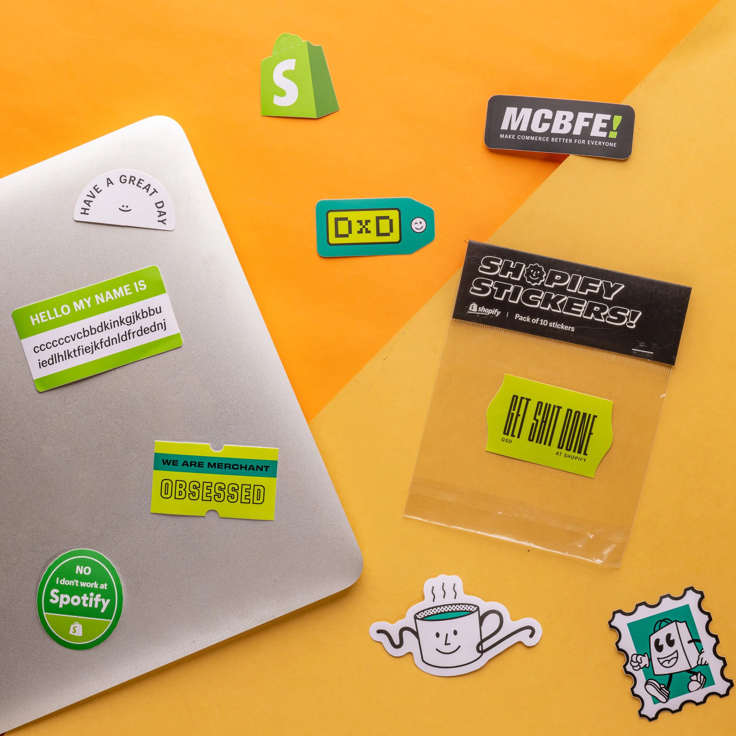 Shopify die-cut laptop stickers and 10-piece sticker pack with black header card in lime and teal brand colours – employee welcome kit stickers Kuala Lumpur