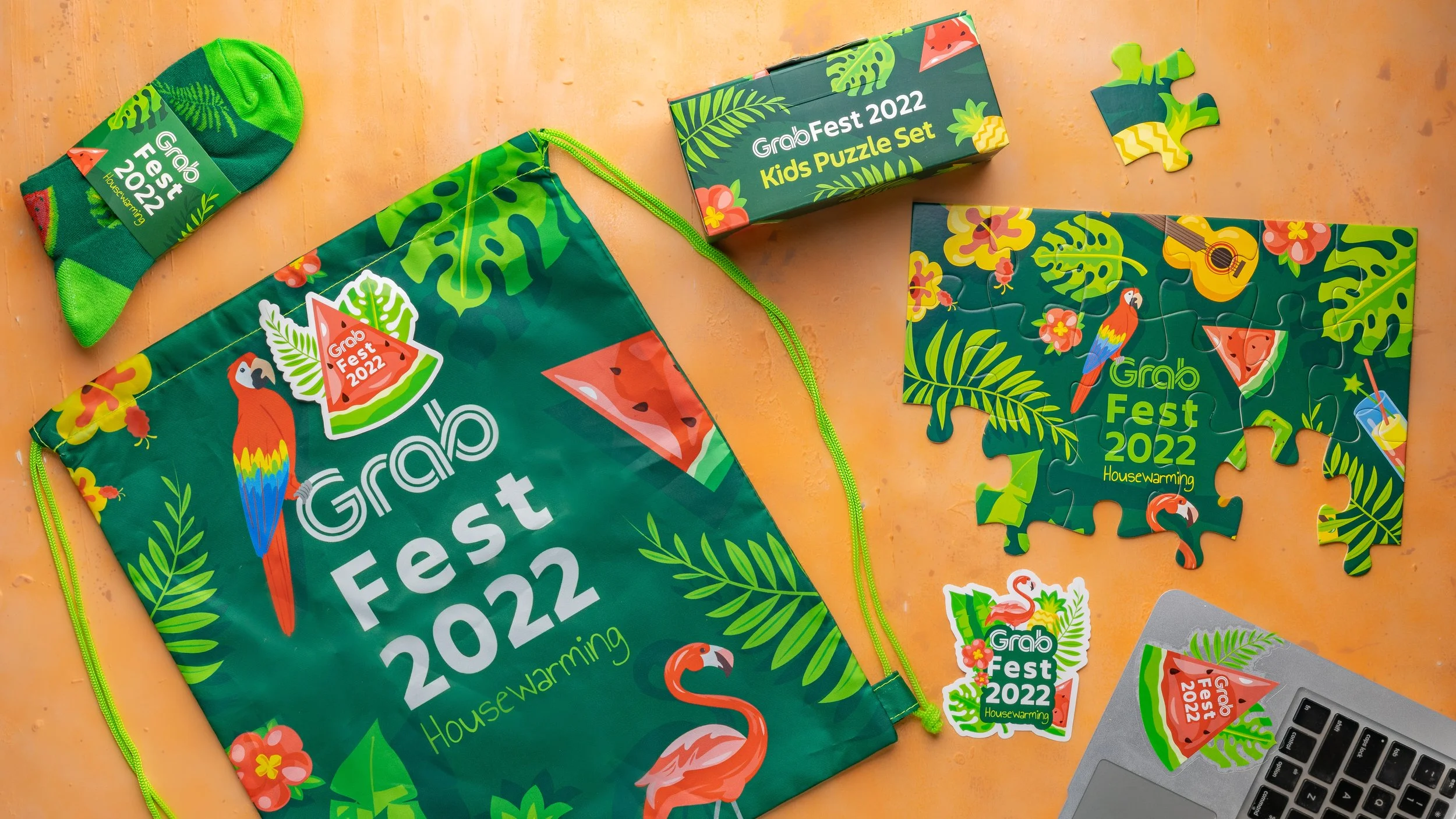 GrabFest 2022 event merchandise — drawstring bag, printed socks and a kids puzzle set