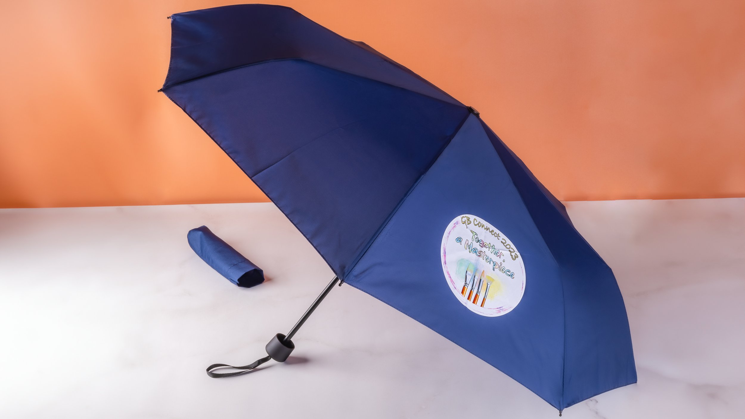 Navy GB Connect 2023 custom umbrella printed with hand-drawn Together a Masterpiece artwork