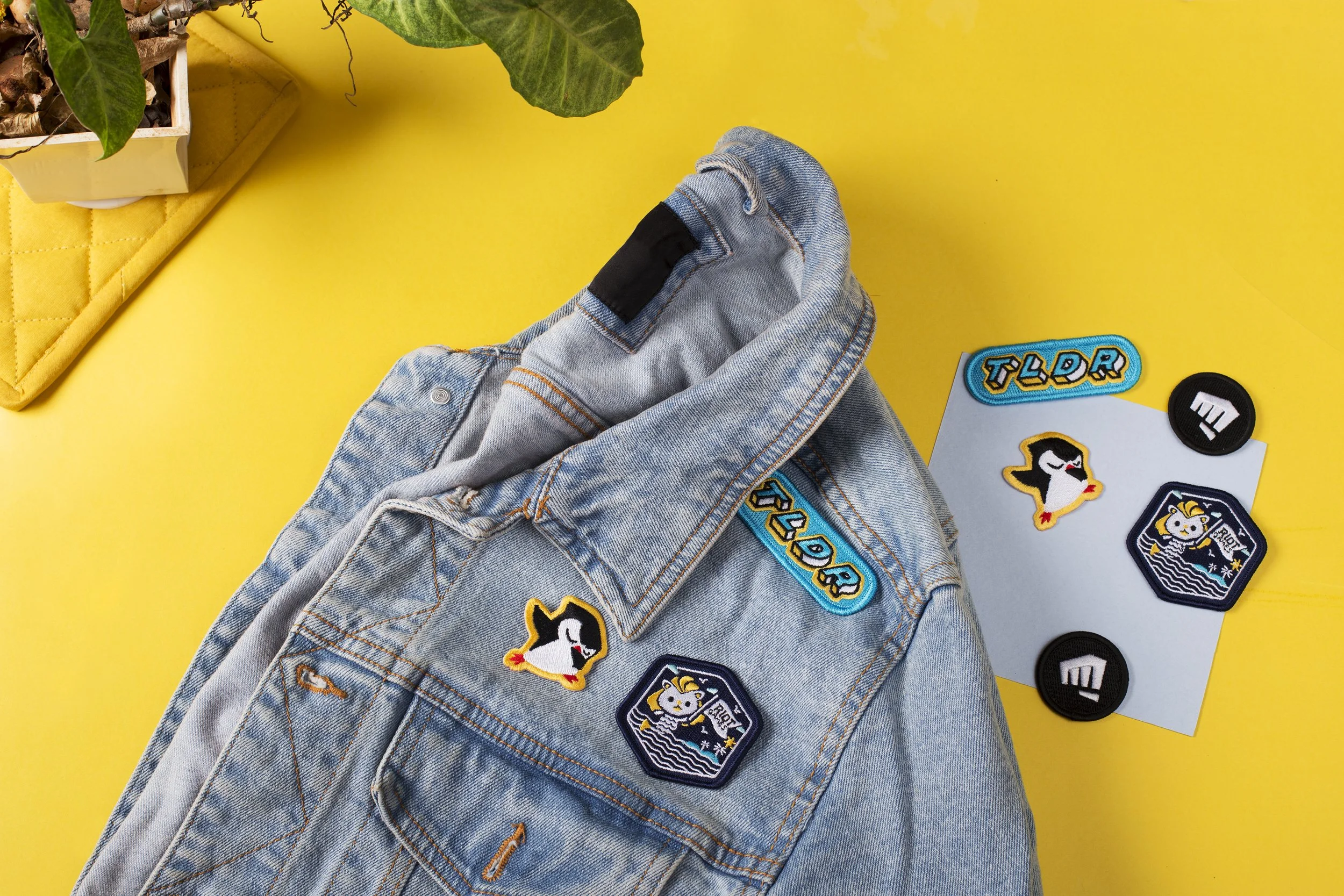Riot Games, penguin and TLDR embroidered patches applied to a denim jacket with spares alongside