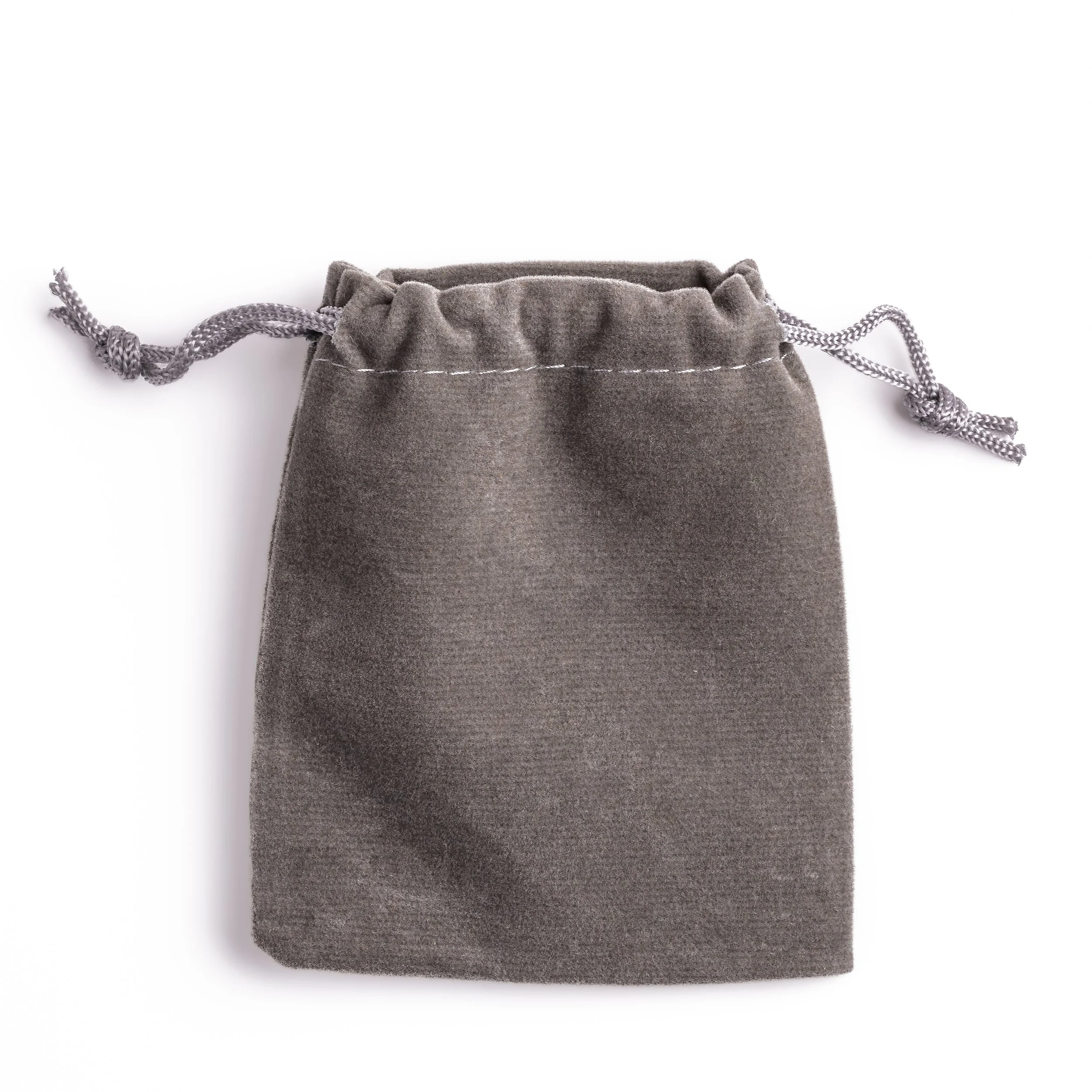 Custom coin in a soft grey velvet pouch with a drawstring