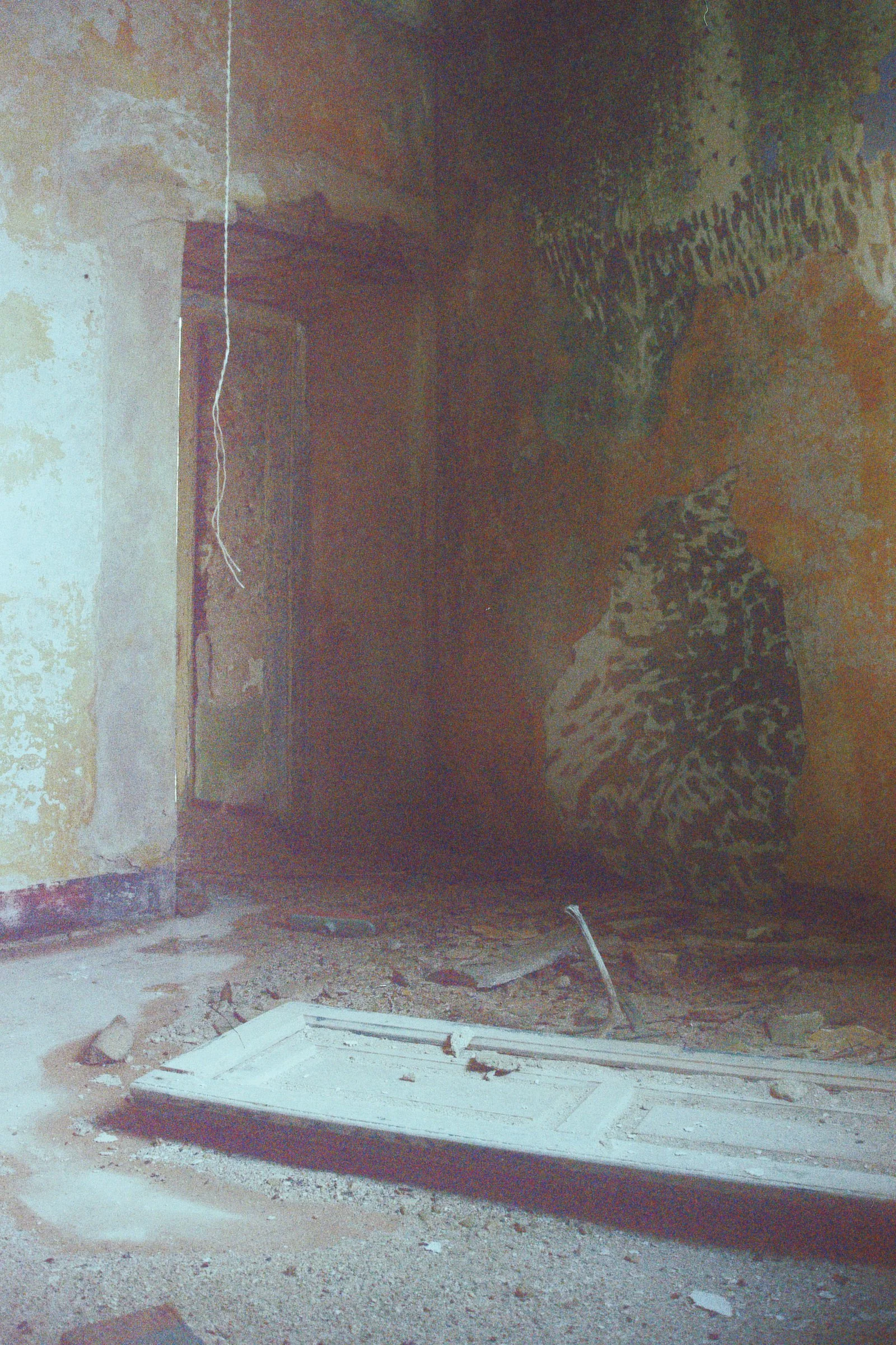 Immagine di un soffitto di una stanza in costruzione o ristrutturazione, con pareti dai colori caldi e scatole di immagazzinaggio o tubi sul pavimento.