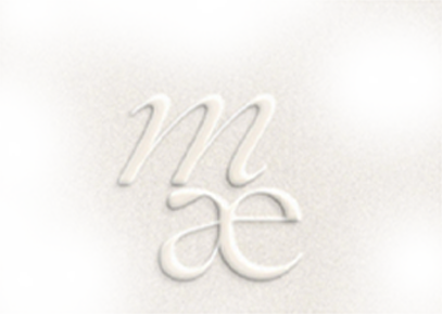 Close-up of a white embossed zodiac symbol for Virgo on a white background.