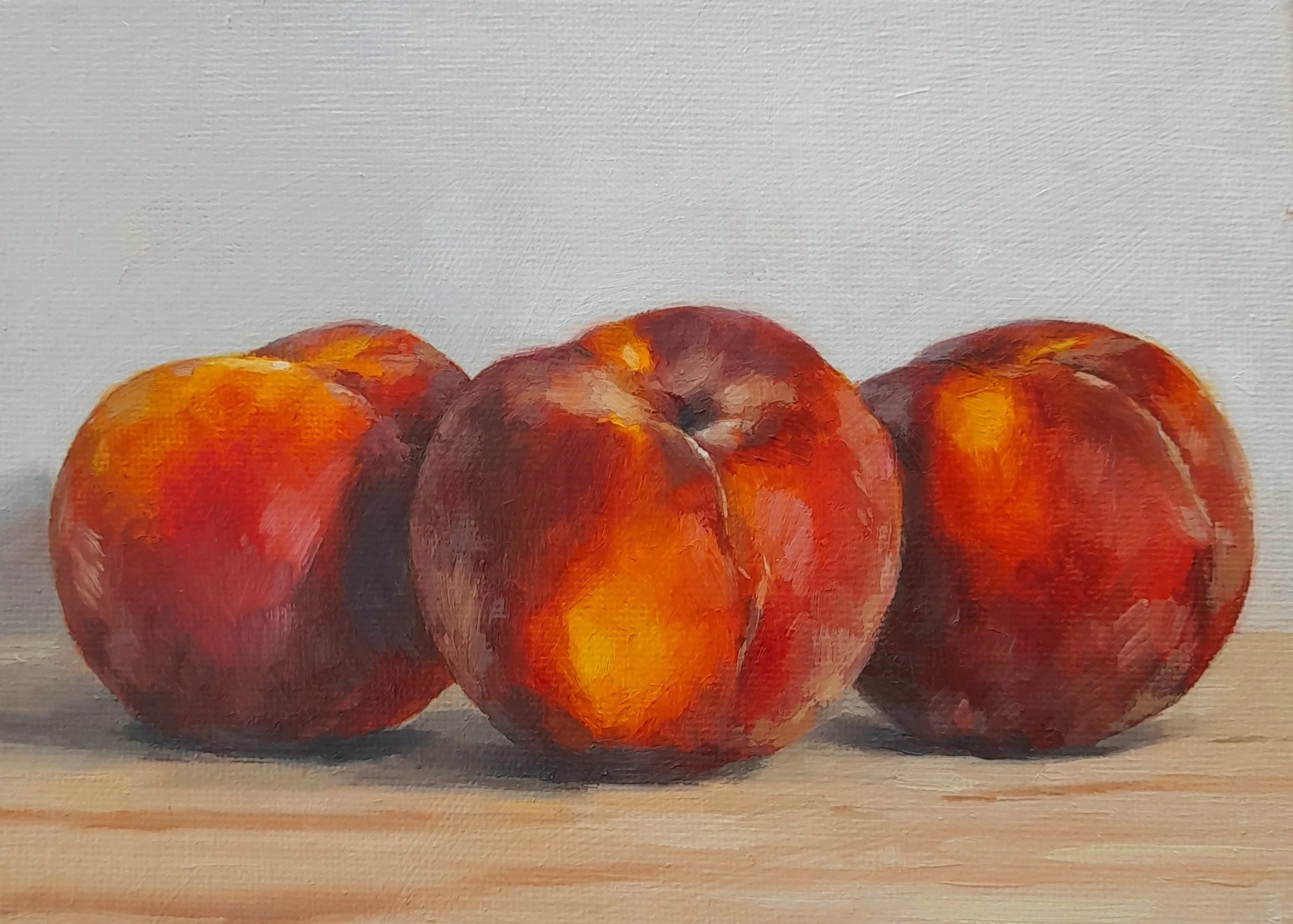 Oil painting of three fuzzy orange peaches resting on a wooden chopping board against a soft neutral background, in a contemporary realism style. By Amanda Selway