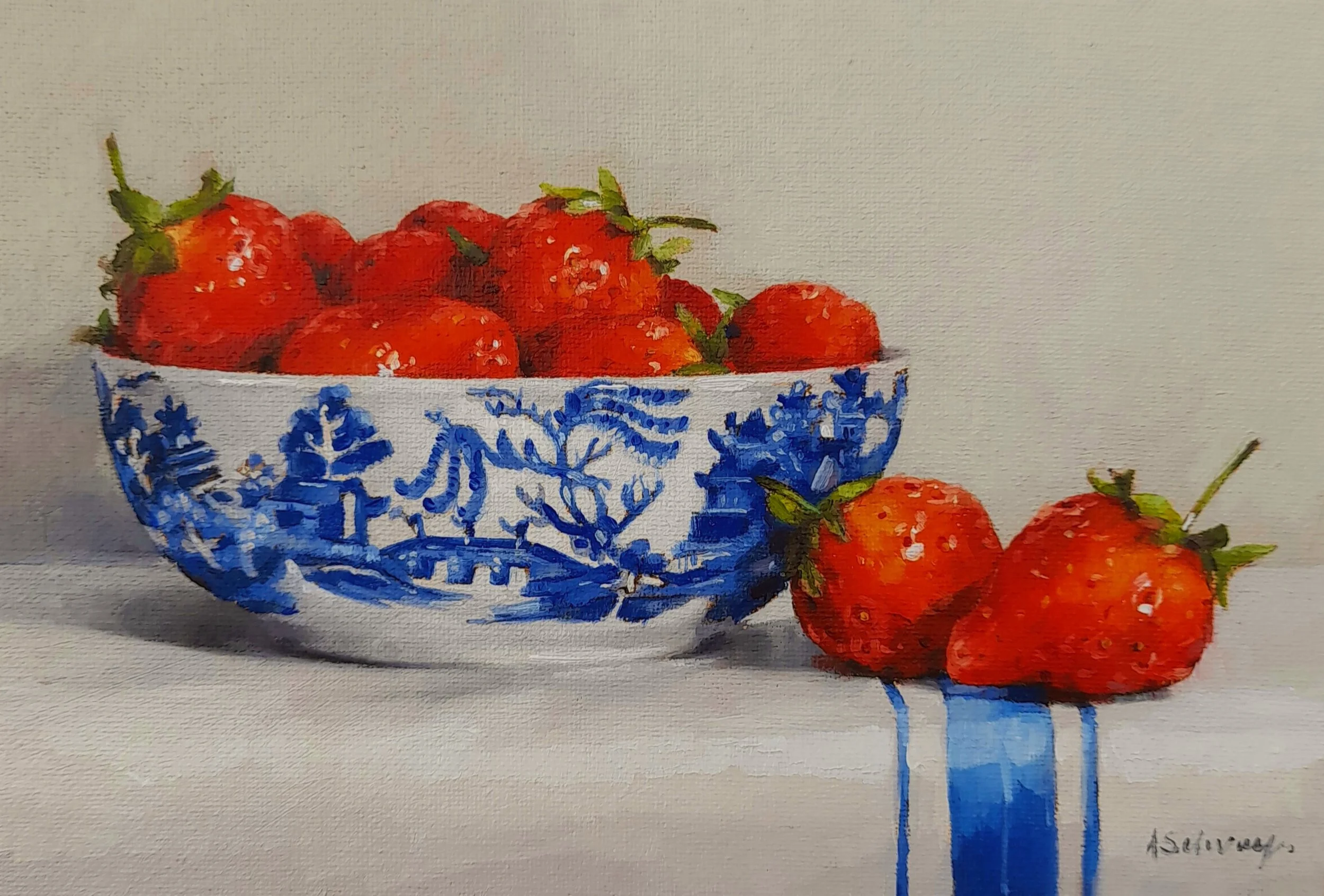 Oil painting of fresh strawberries in a decorative blue and white bowl, with several strawberries resting beside it on a white cloth with a blue coloured stripe and some strawberries outside of it. By Artist Amanda Selway