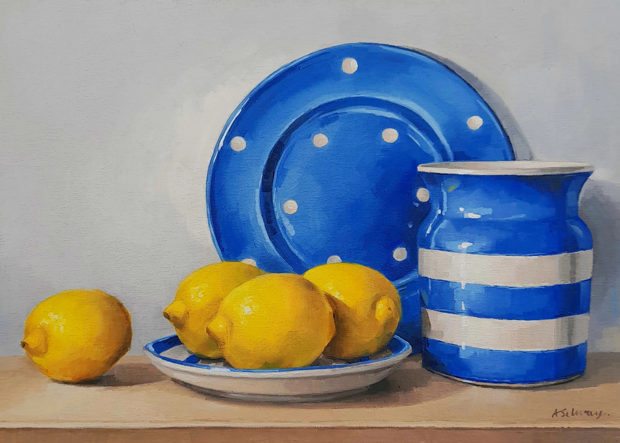 Still life oil painting of a blue and white polka dot teapot, a matching cup, and a plate of lemons on a table, in a contemporary realism style.