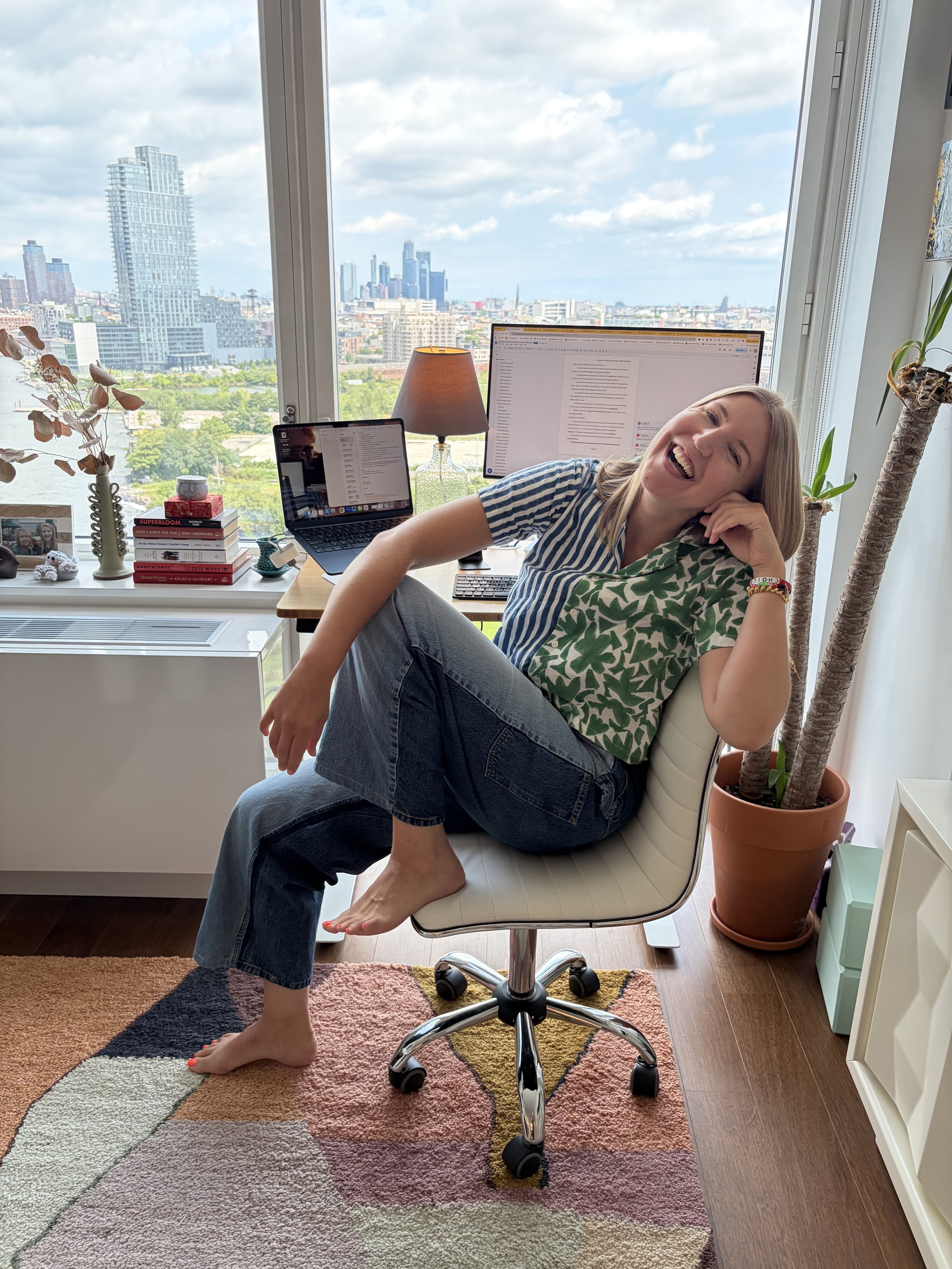Summer Lindman smiling and sitting in front of her desk with her computer open.