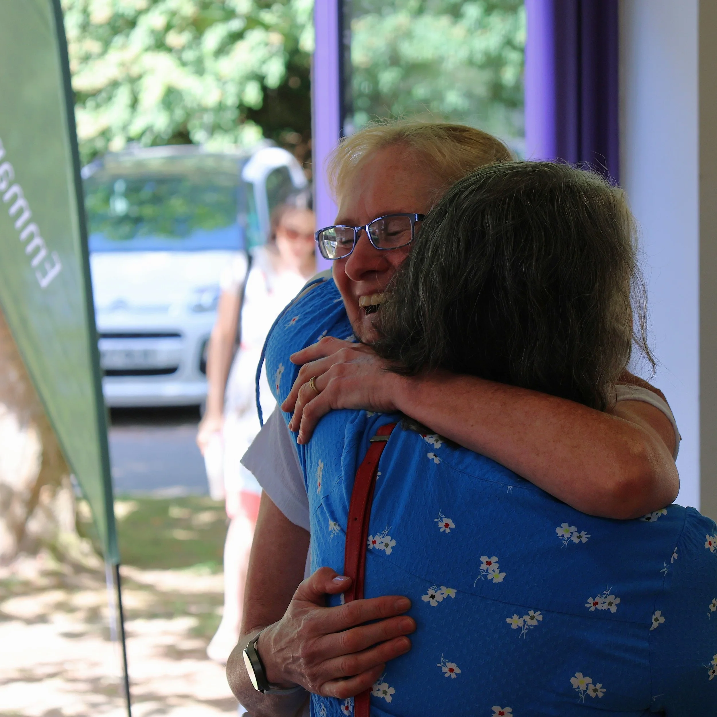 Two women hugging at church.