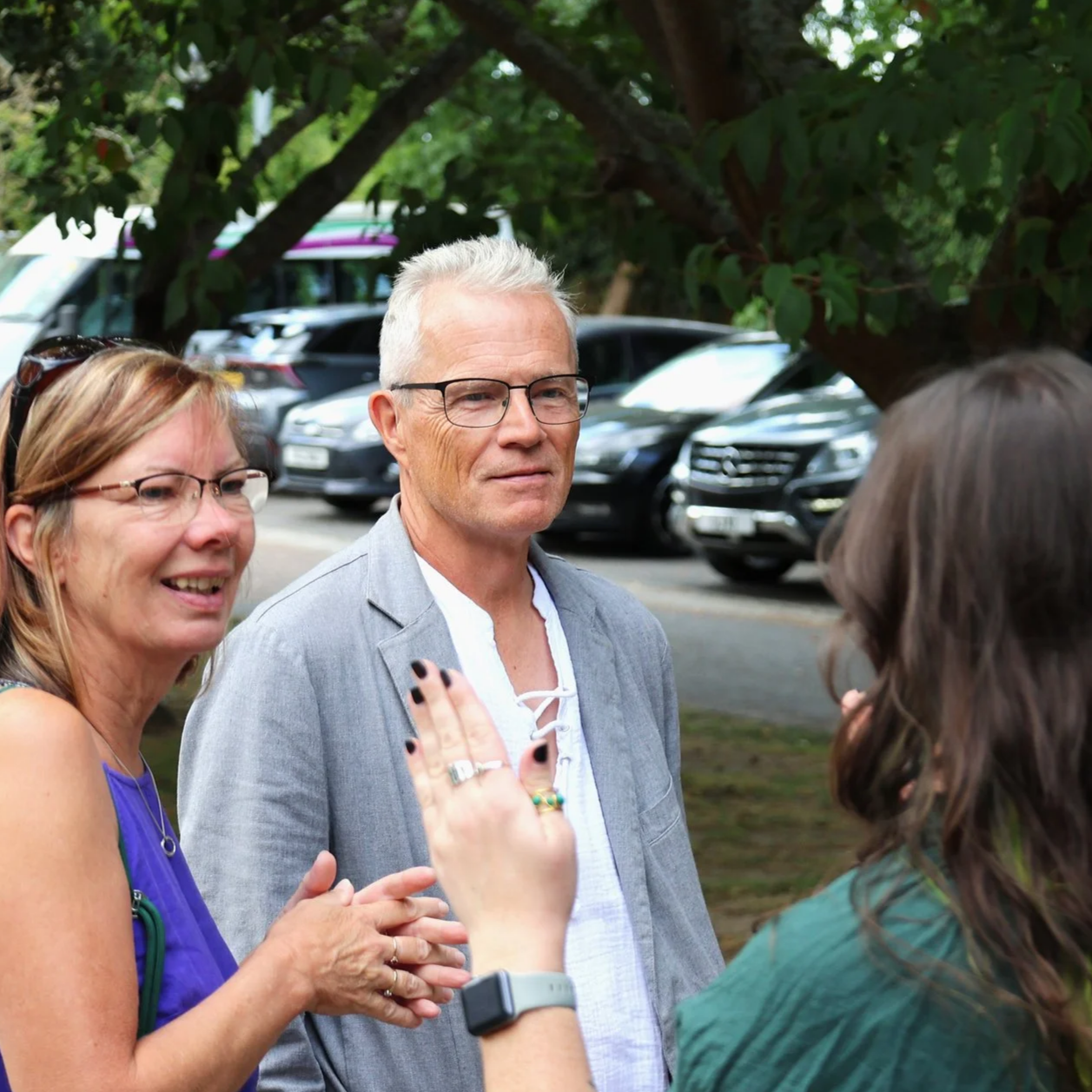 A group of adults chatting outside church.