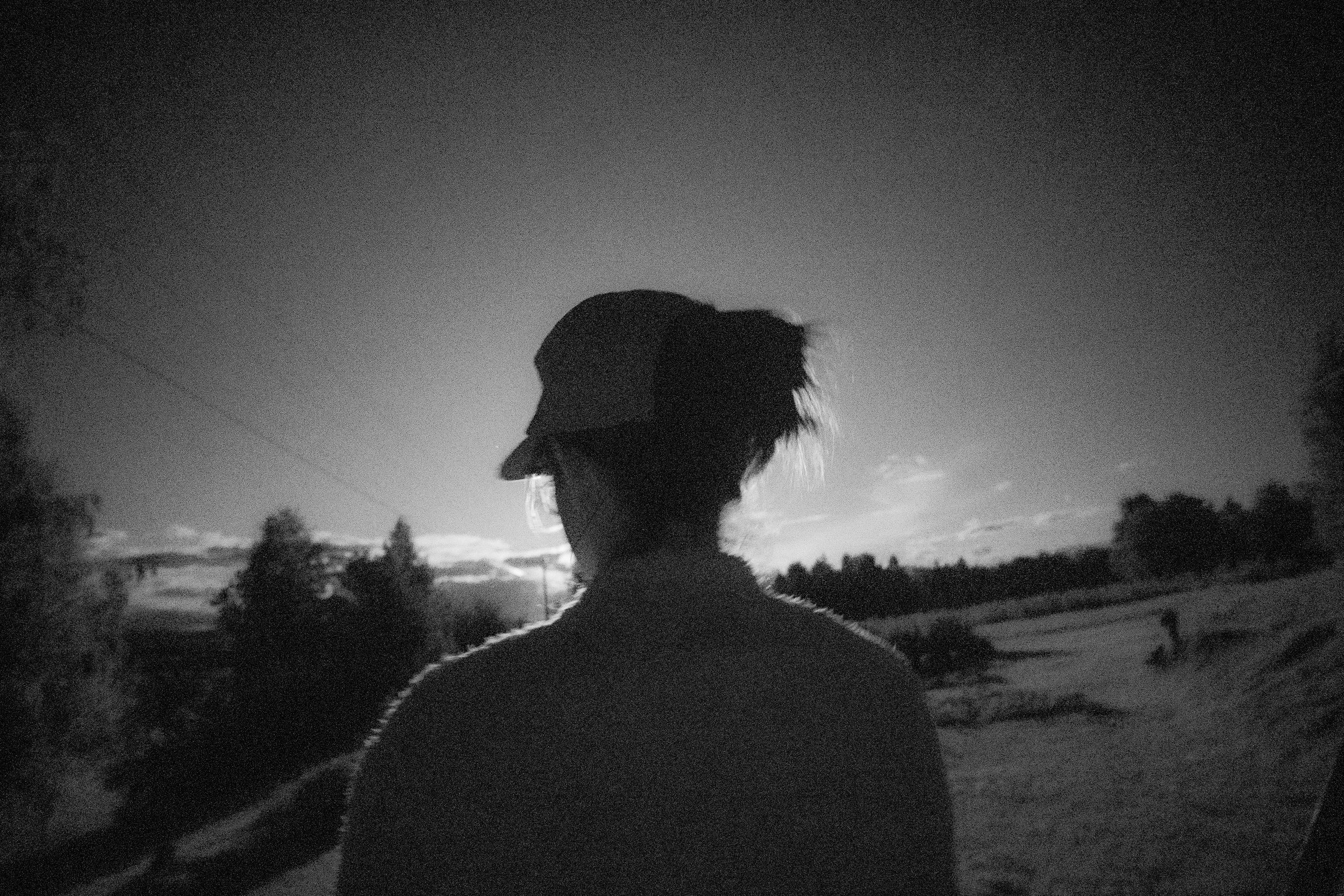 Monochrome fine art portrait silhouetted against the Arctic midnight sun in Boden, Sweden by Joe Macleod