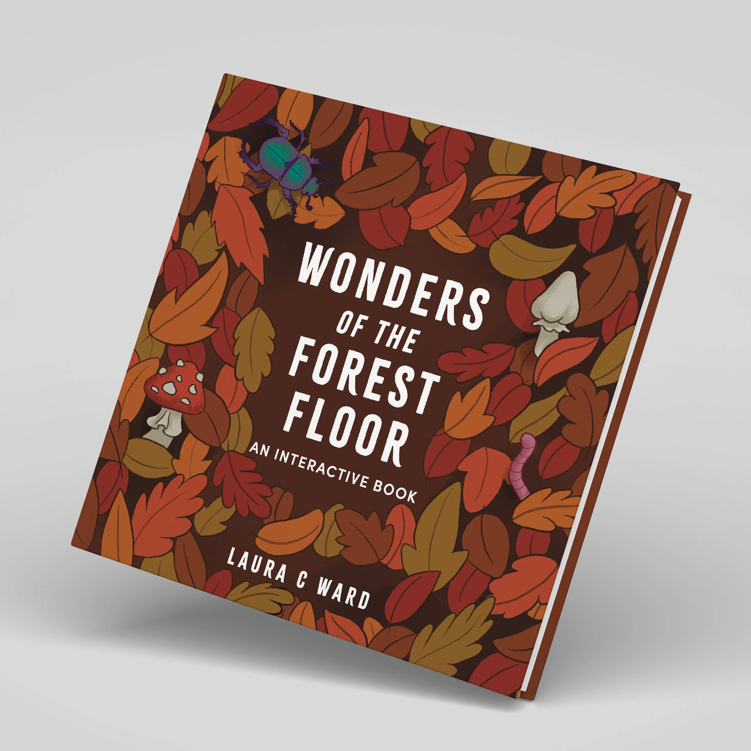 Close-up of a book cover titled 'Wonders of the Forest' by Laura C. Ward featuring a design with colorful autumn leaves and small forest animals.