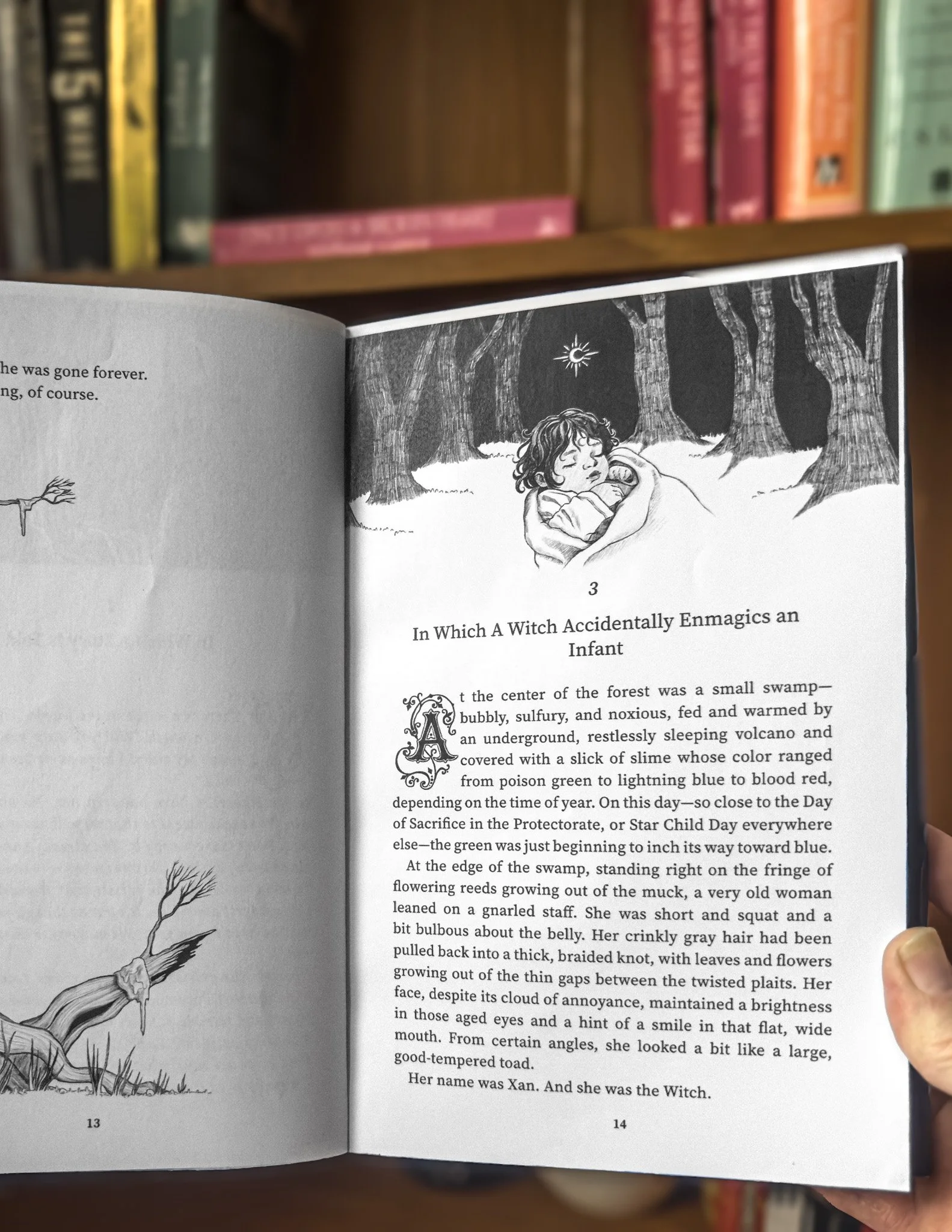 Open book showing black and white illustration of a girl sleeping under a forest with a moon and stars, with text discussing a witch and an infant, and other text on the left page.