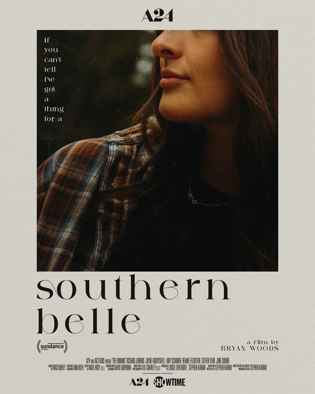 Close-up of a woman's face and shoulder, wearing a plaid shirt and necklace, with film poster background for "Southern Belle" by Bryan Woods.