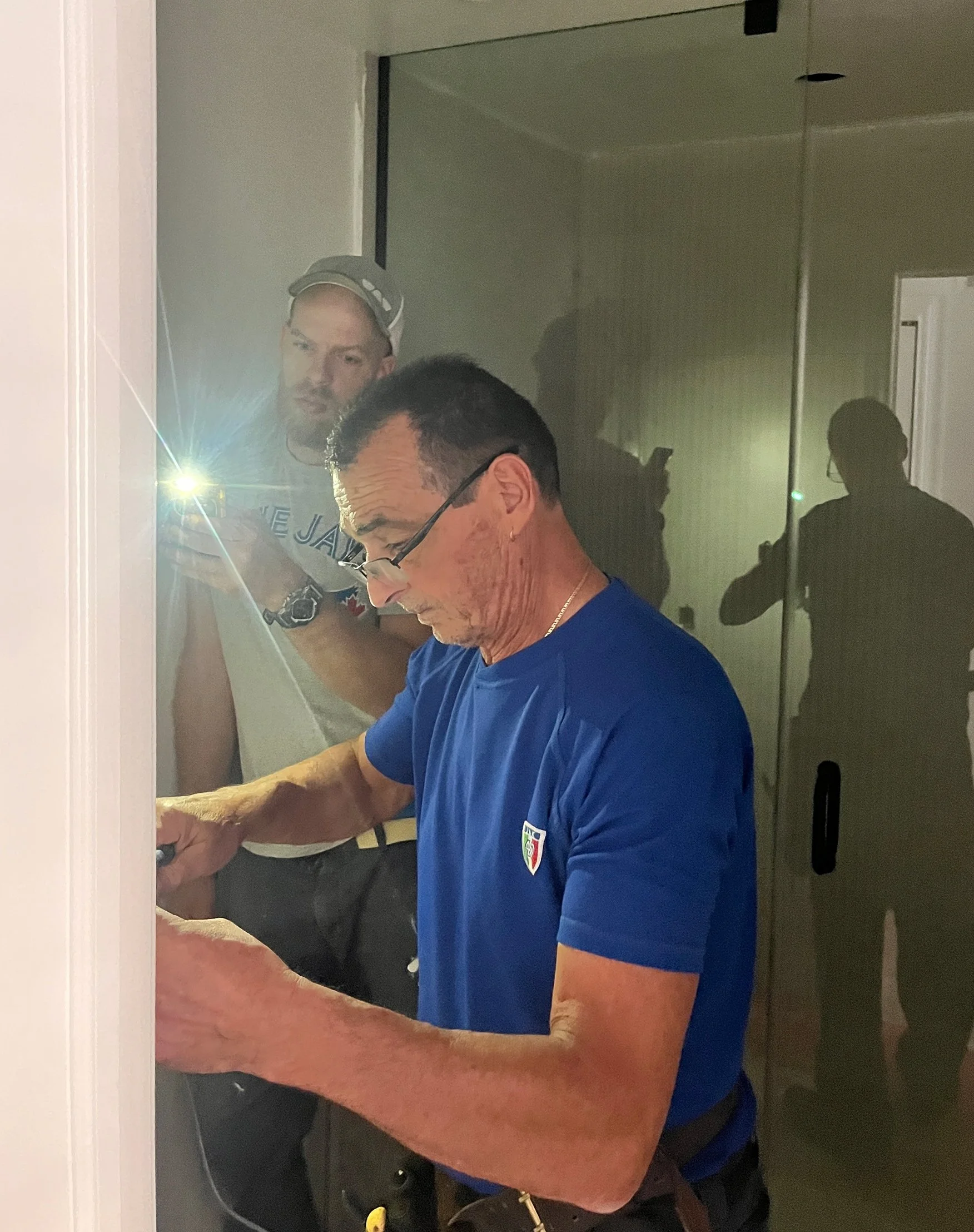 The team troubleshooting a detail together — good collaboration between trades is what keeps a project like this on track.