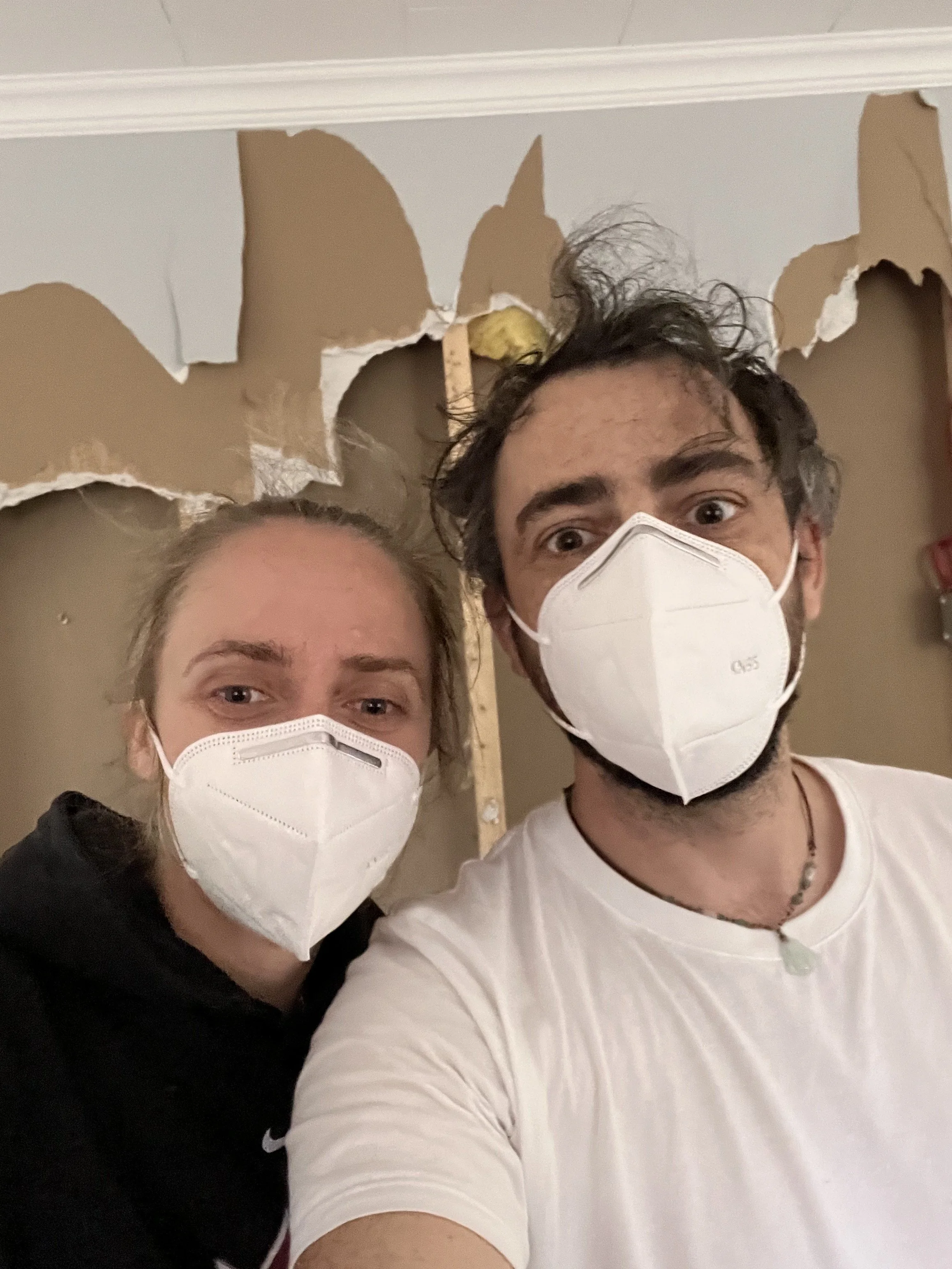 Vogman Design + Build owner and contractor wearing dust masks during drywall removal on a Toronto renovation project