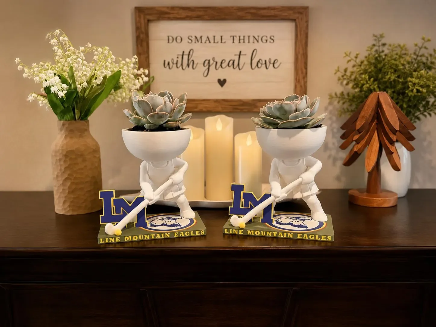 Two personalized field hockey player planters in Line Mountain Eagles colors holding succulents