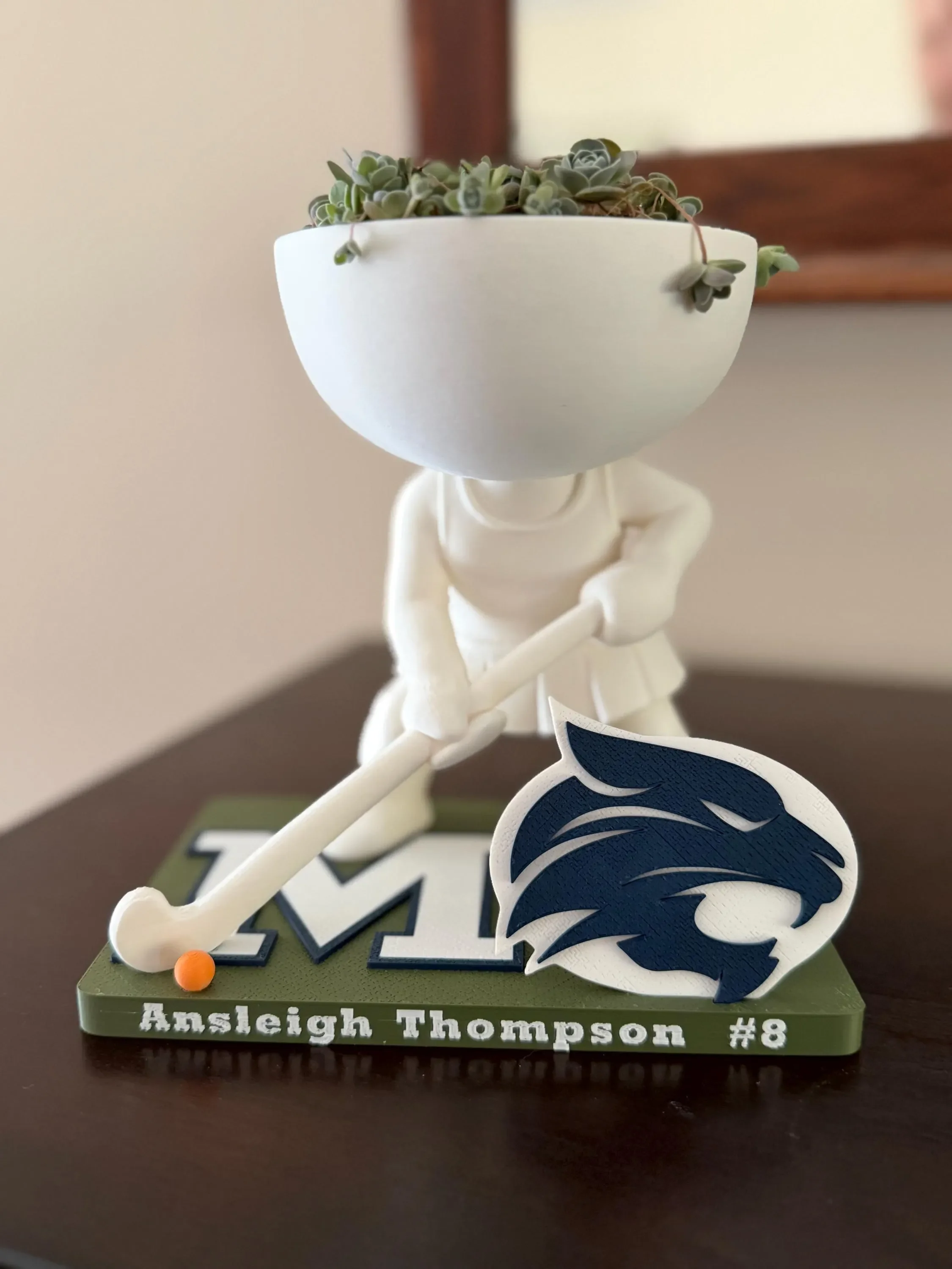 Field hockey player planter with a succulent, Ansleigh Thompson number 8