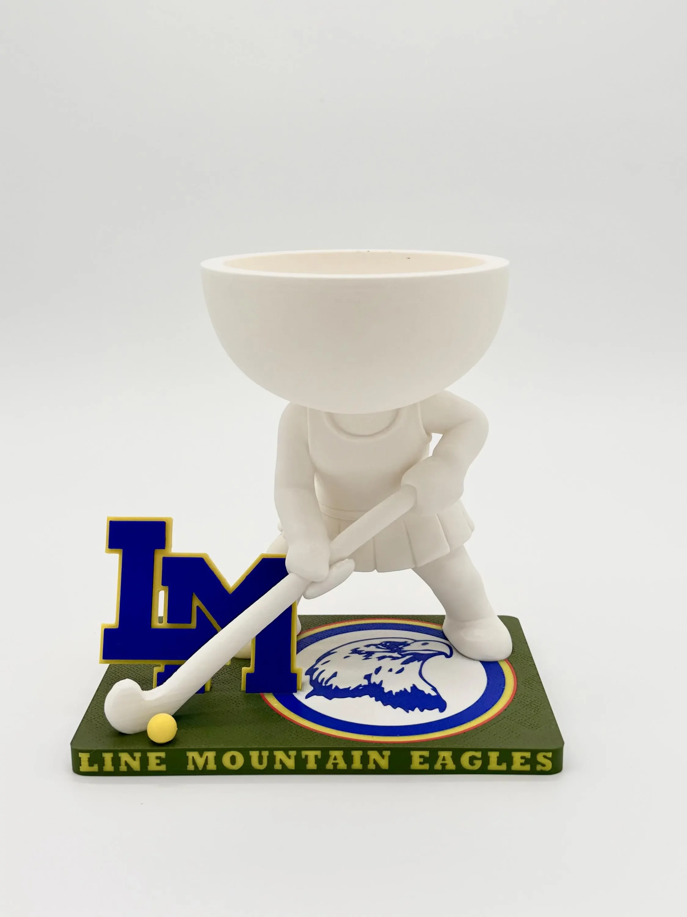 Field hockey player planter on a white background showing the Line Mountain Eagles base, stick and empty bowl
