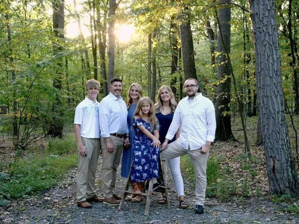 Joe, Sara and their four kids in the woods
