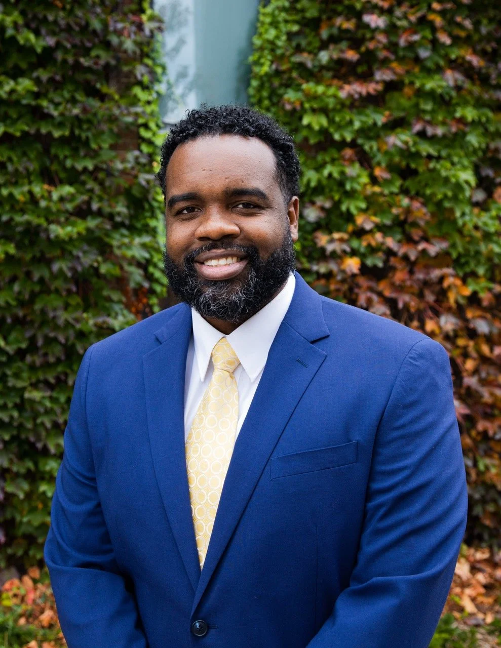 Kris-Andre Smith, Toronto lawyer and Managing Partner of Infinity Legal, smiling in a blue suit
