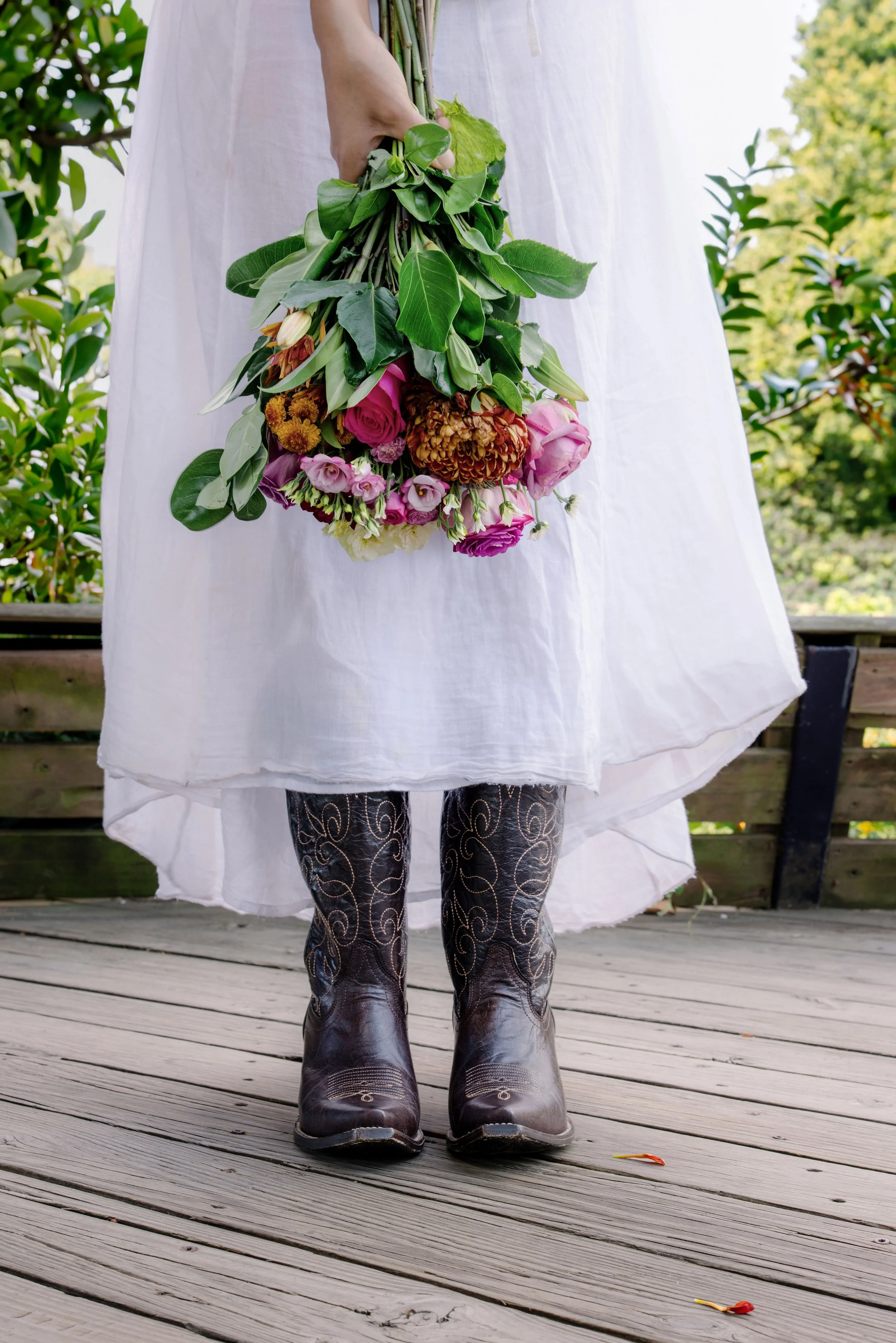 Editorial & Brand — Ari styled with statement boots and flowers for a fashion-forward editorial portrait.