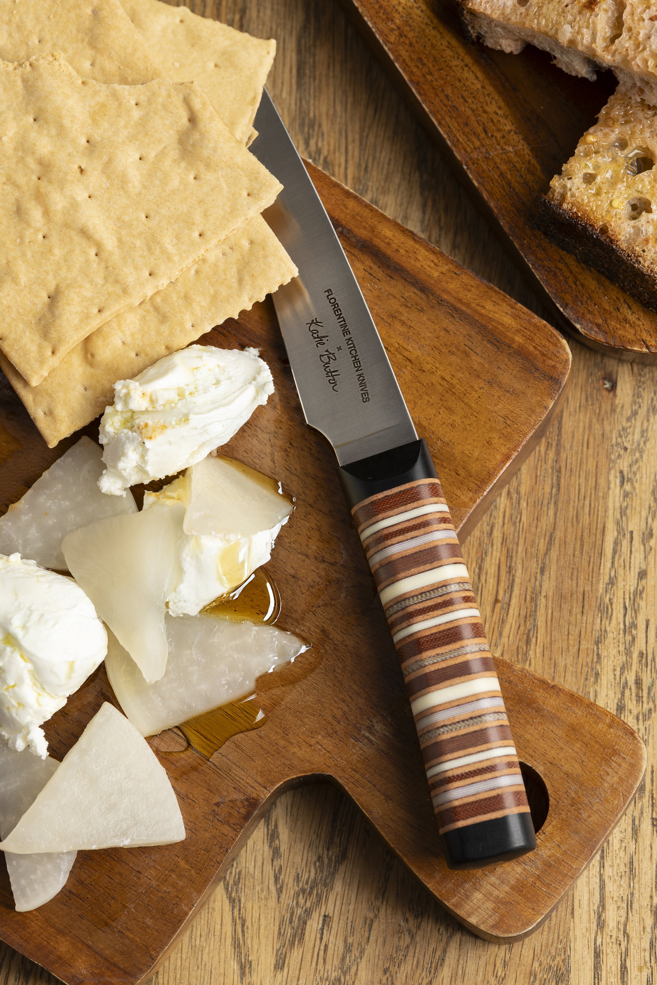 Chef’s knife slicing artisan cheese for a food brand campaign, photographed by Fraiche Photography in Asheville, North Carolina.