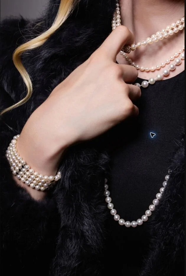 Luxury Jewelry — Pearl necklace and diamond bracelet styled with black fur for a refined editorial portrait.