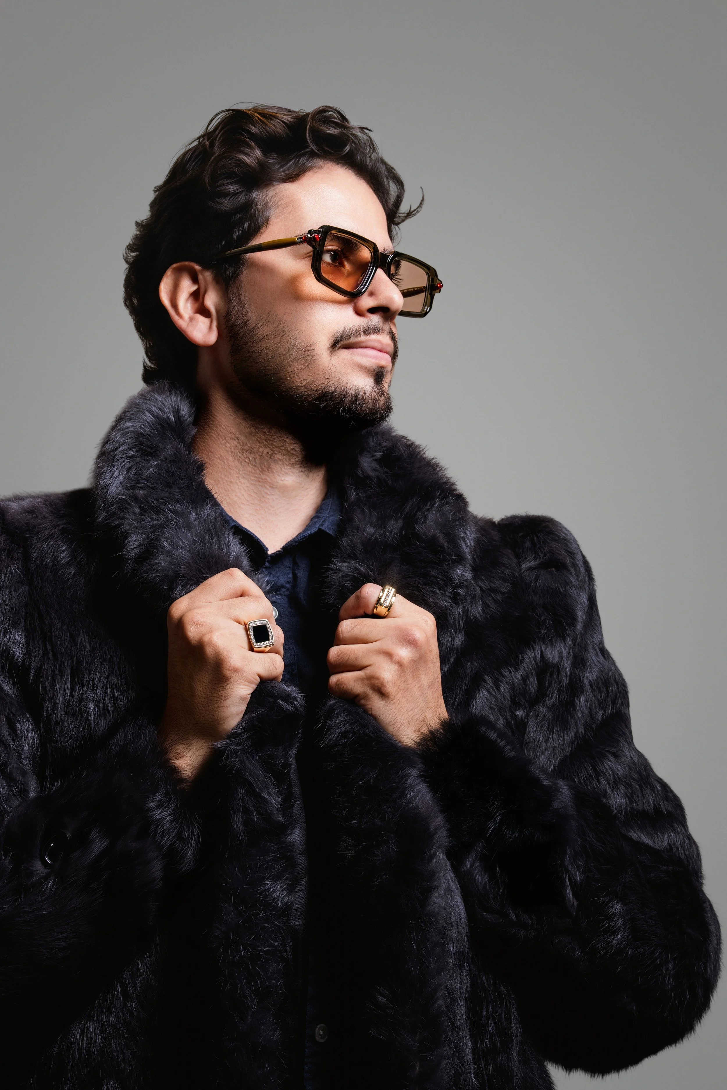 Model wearing statement rings and sunglasses in a cinematic luxury jewelry campaign by Fraiche Photography.