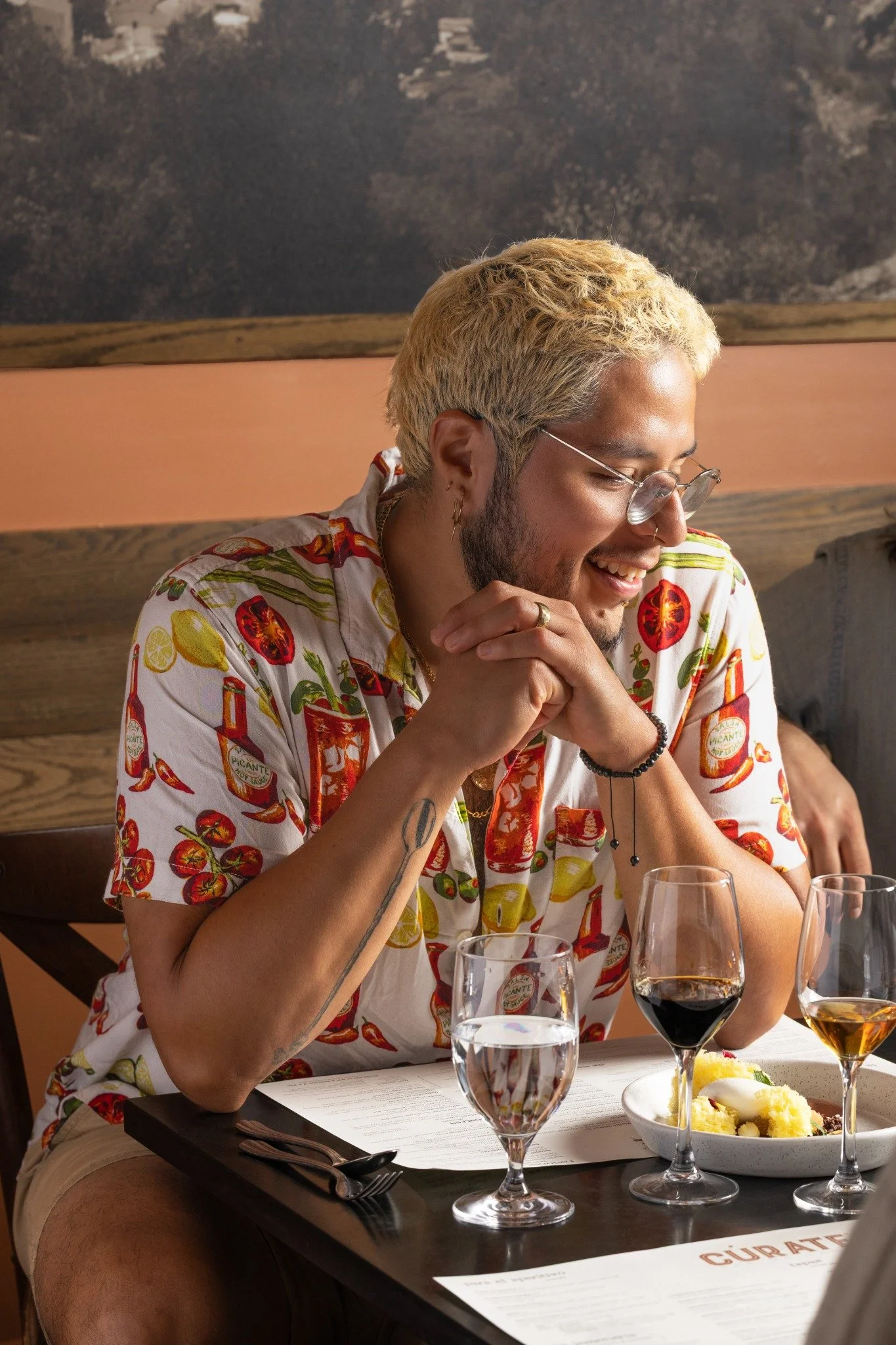 Hospitality — A guest enjoying wine and a plated dish inside Cúrate in Asheville, capturing the restaurant experience.