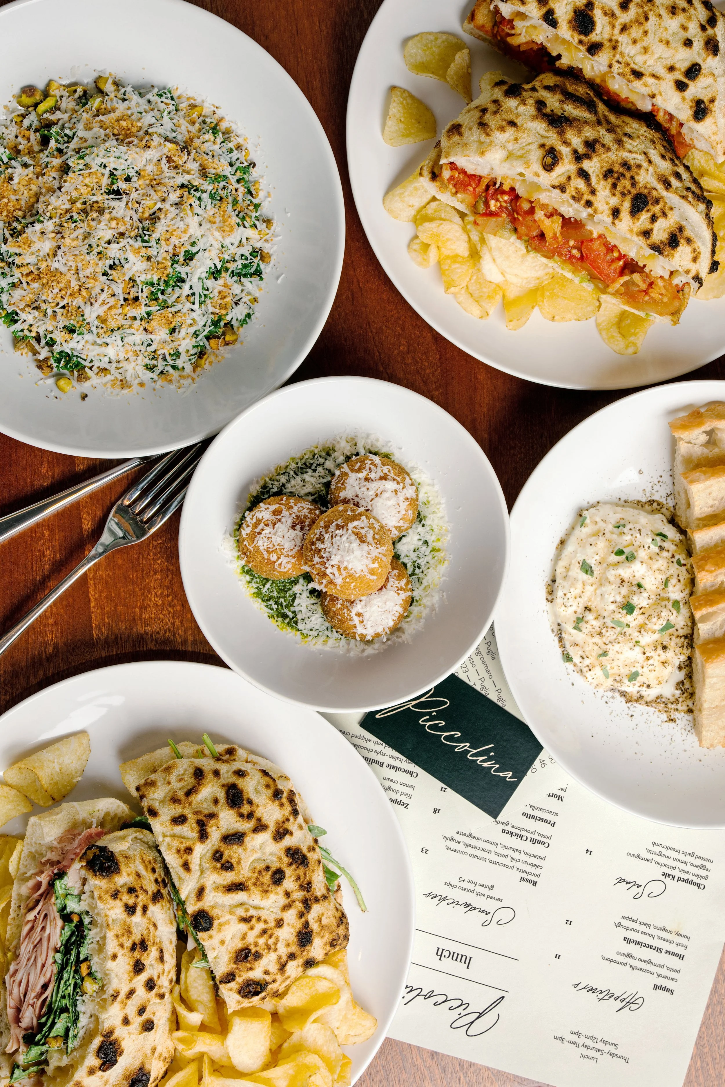 Italian restaurant tablescape with shared plates, photographed by Fraiche Photography for Edible Asheville.