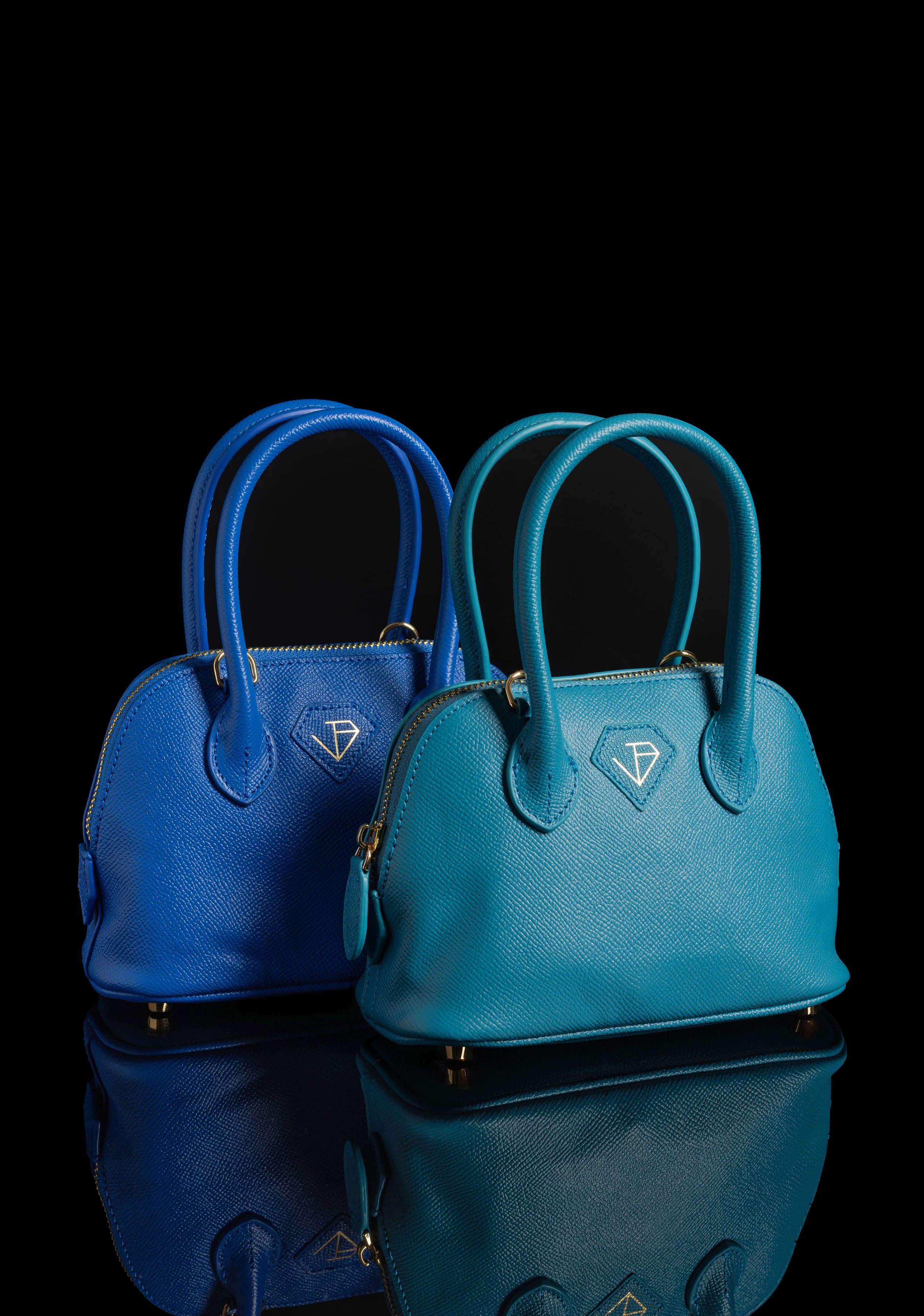 Editorial & Brand — Blue leather handbag collection arranged in a refined studio product composition.