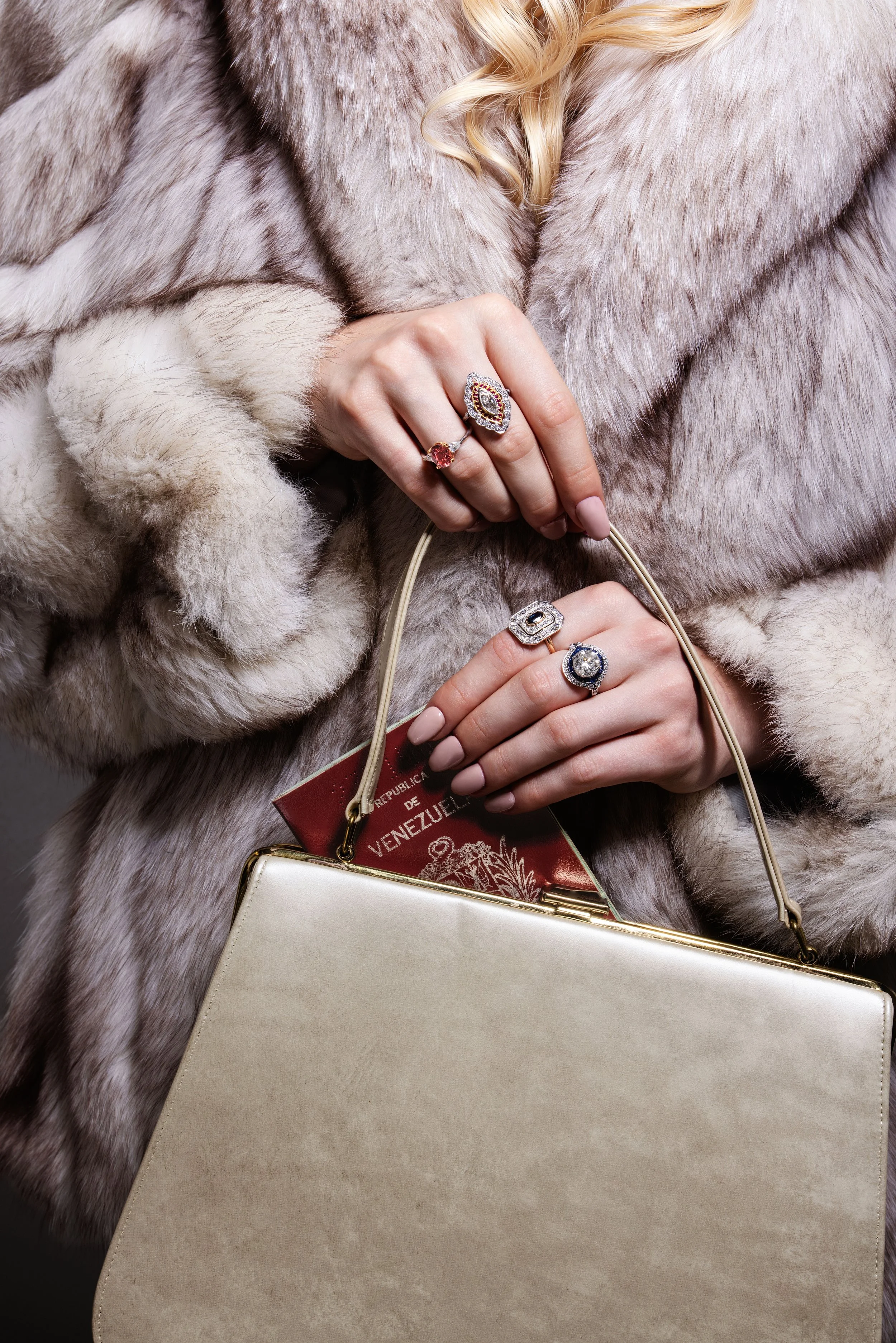 Luxury Jewelry — Diamond rings and bracelet styled with white fur for a polished editorial campaign portrait.