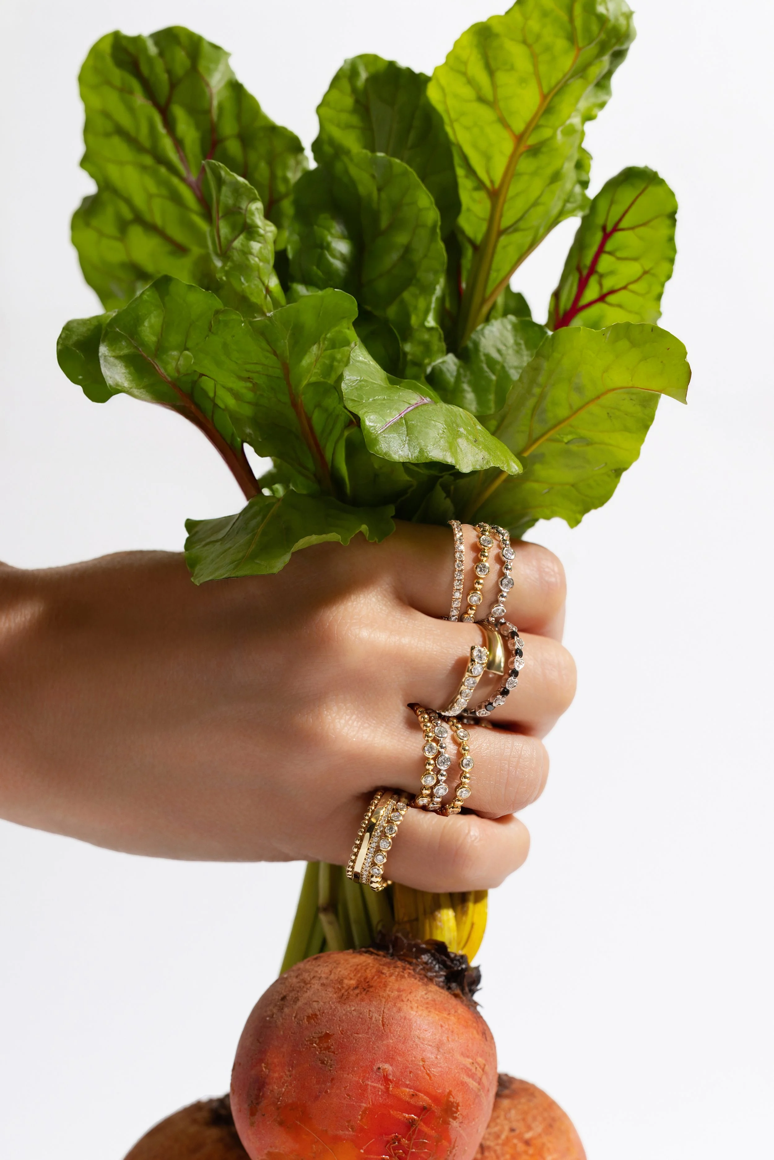 Luxury Jewelry — Gemstone ring stack styled with fresh beets for a colorful spring editorial still life.
