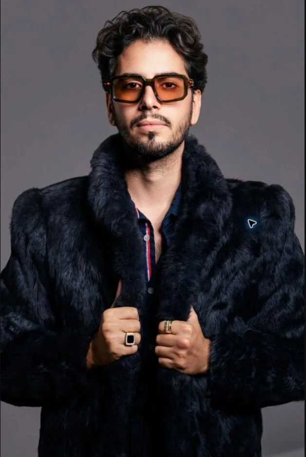 Luxury Jewelry — Men’s rings and sunglasses styled with a black fur coat for a bold campaign portrait.