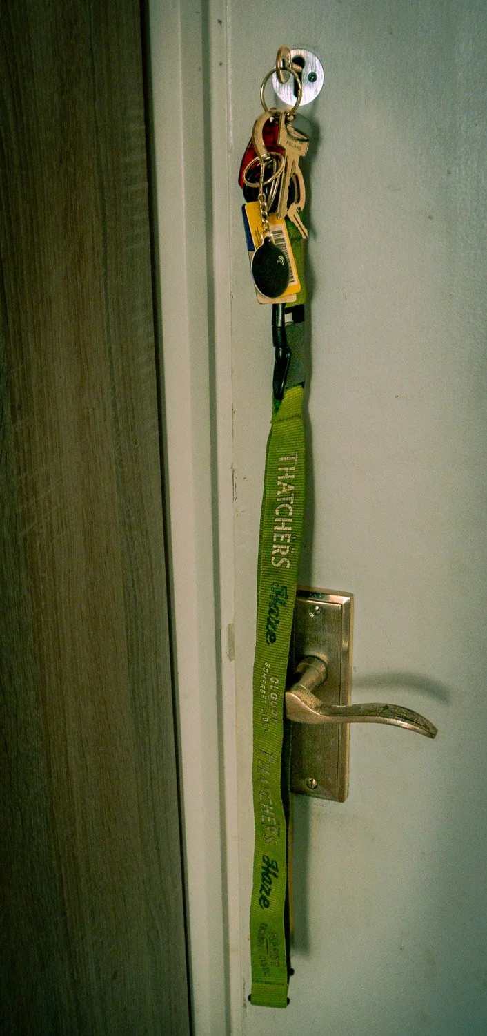 Door with attached keys, keyring, remote, and a green keychain strap labeled "TITACHERS _School".