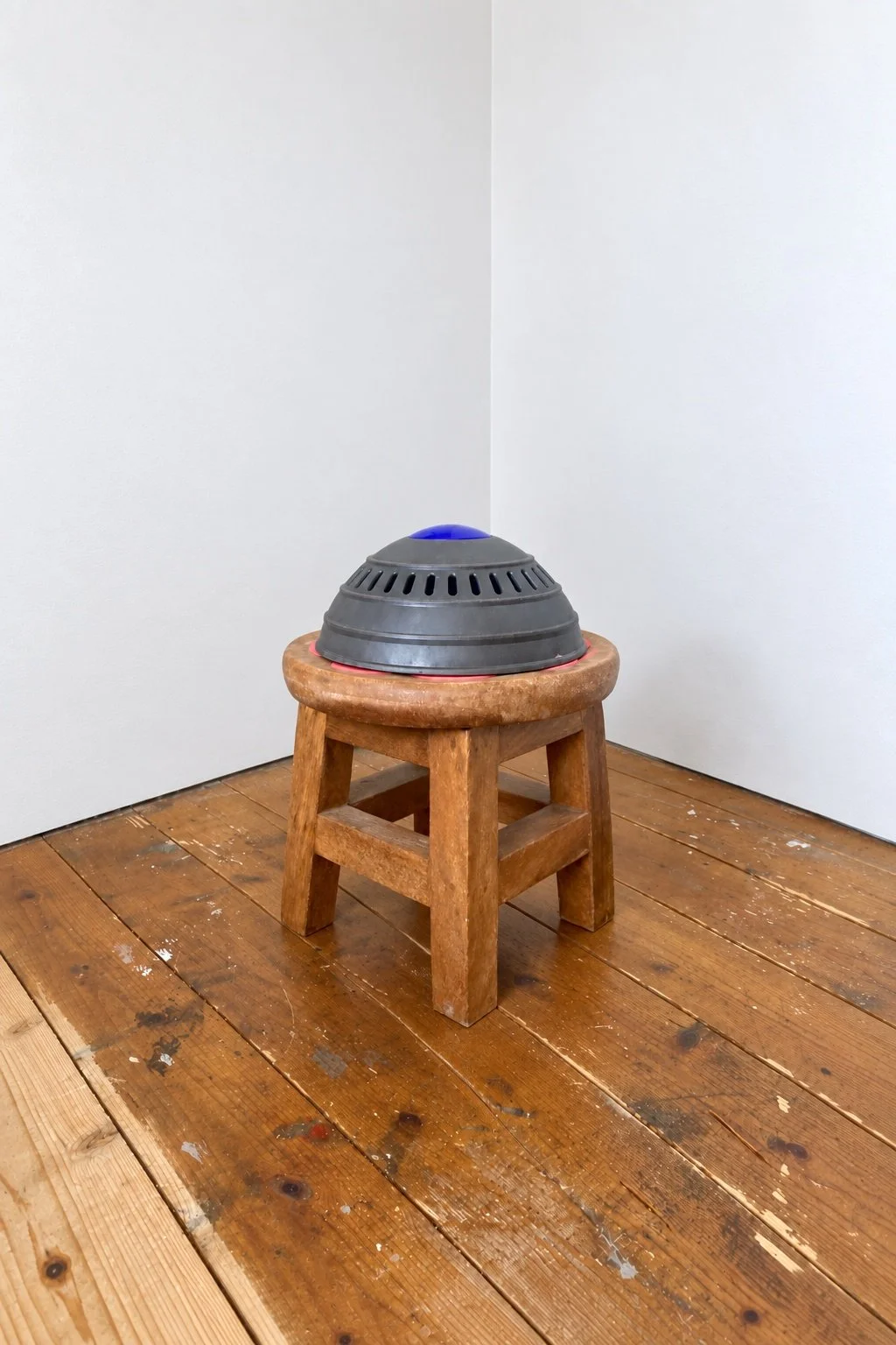 a sculpture made using a child's round wooden stool  and the top of a dyson vacuum cleaner. i called it R2Dy2 because it looks like the Star Wars Robot. Joy as an Act of Resistance in Disability