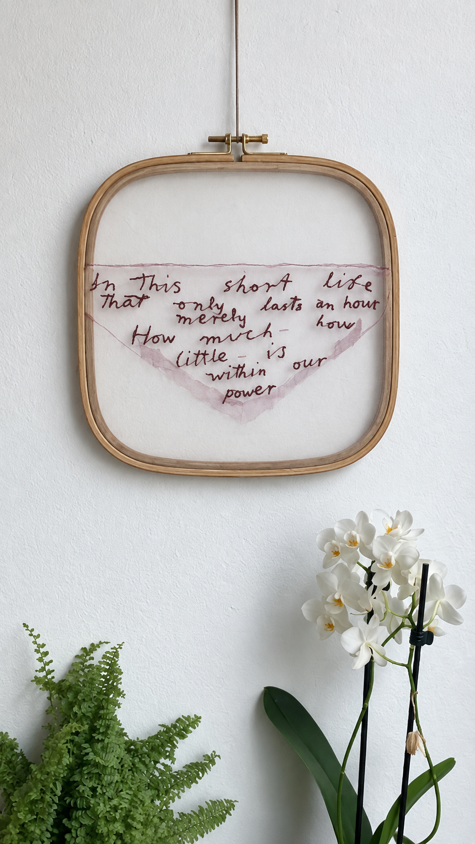emily dickinson's poem 'in this short life' is embroidered onto organza using her handwriting and silk paint outlining the envelope on which the poem was written. the embroidery hoop is made from bamboo