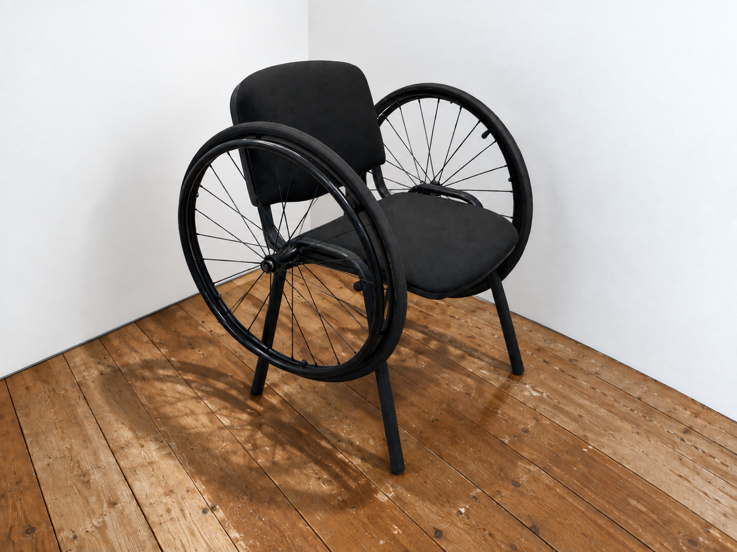 wheeled chair sculpture one - a black chair with black wheelchair wheels for arms