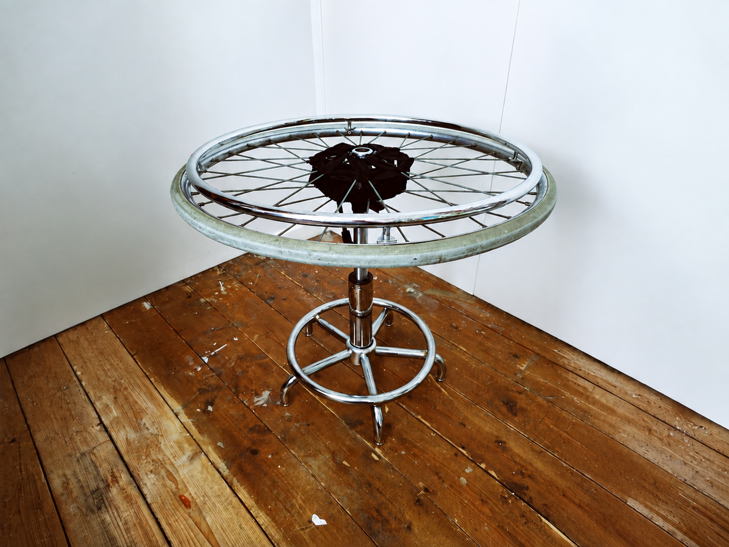 wheeled chair sculpture two a 1960s wheelchair wheel sits atop a deconstructed wheeled stool. you cant sit on it but you can spin itstool