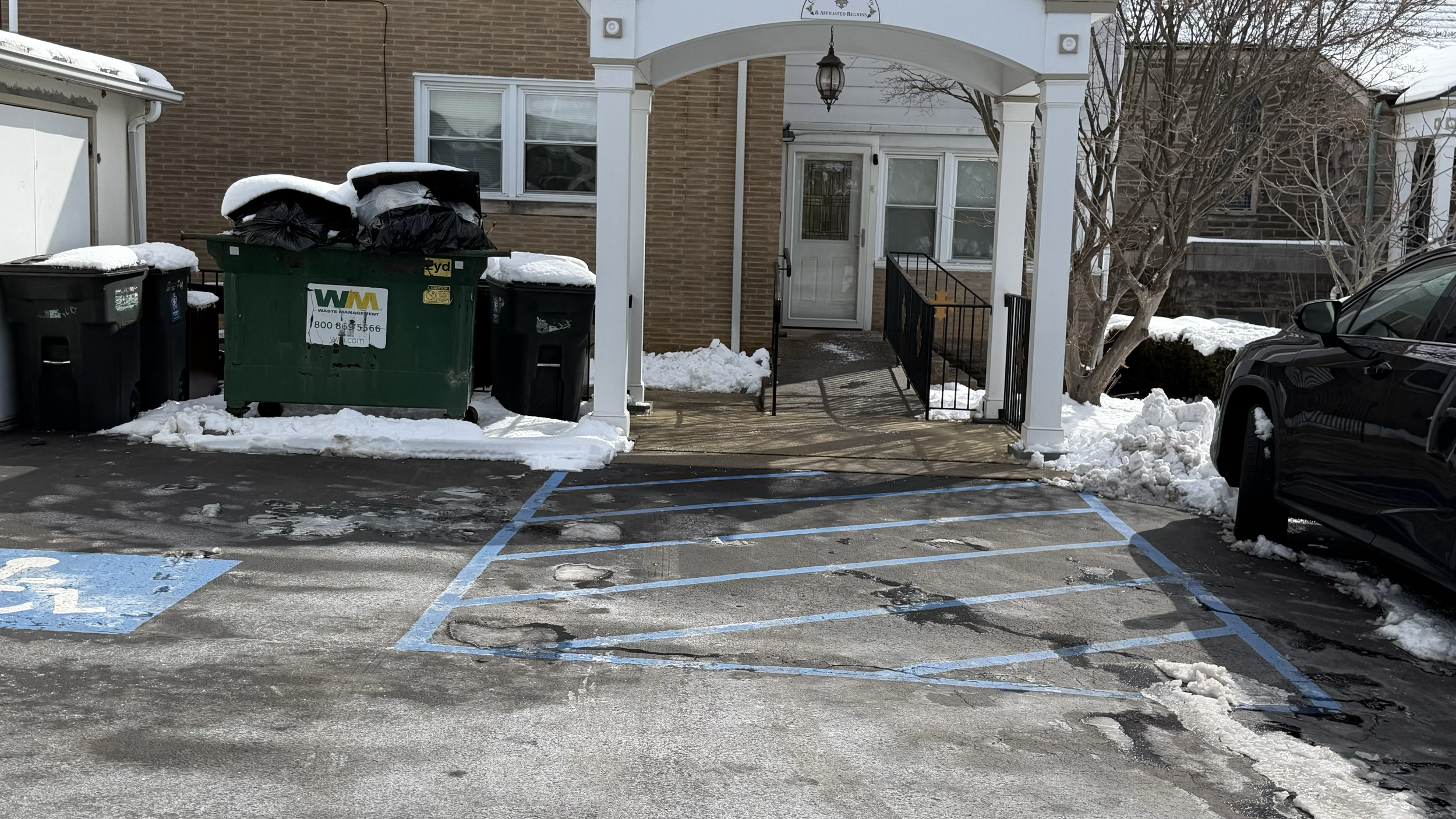 Residential driveway cleared of snow following a winter storm, providing access to the home's garage and entrance while reducing snow accumulation on paved surfaces.